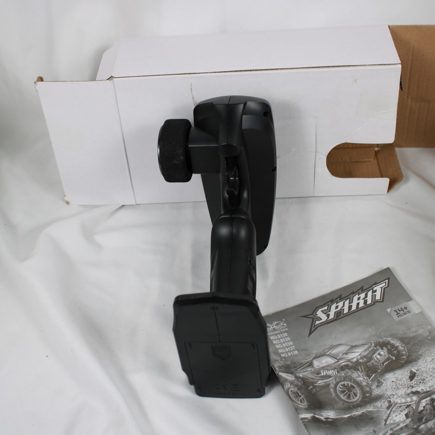 Black car mount on a white surface with a cardboard box and Sprint product packaging.