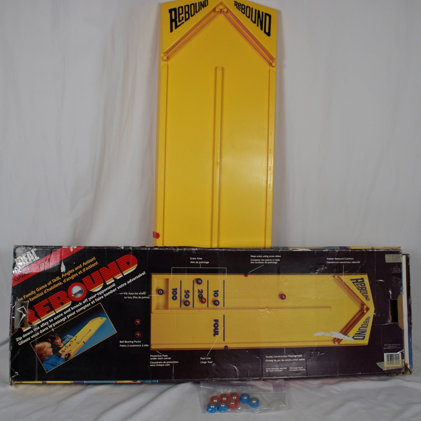 Yellow toy rebounder with packaging on a white background