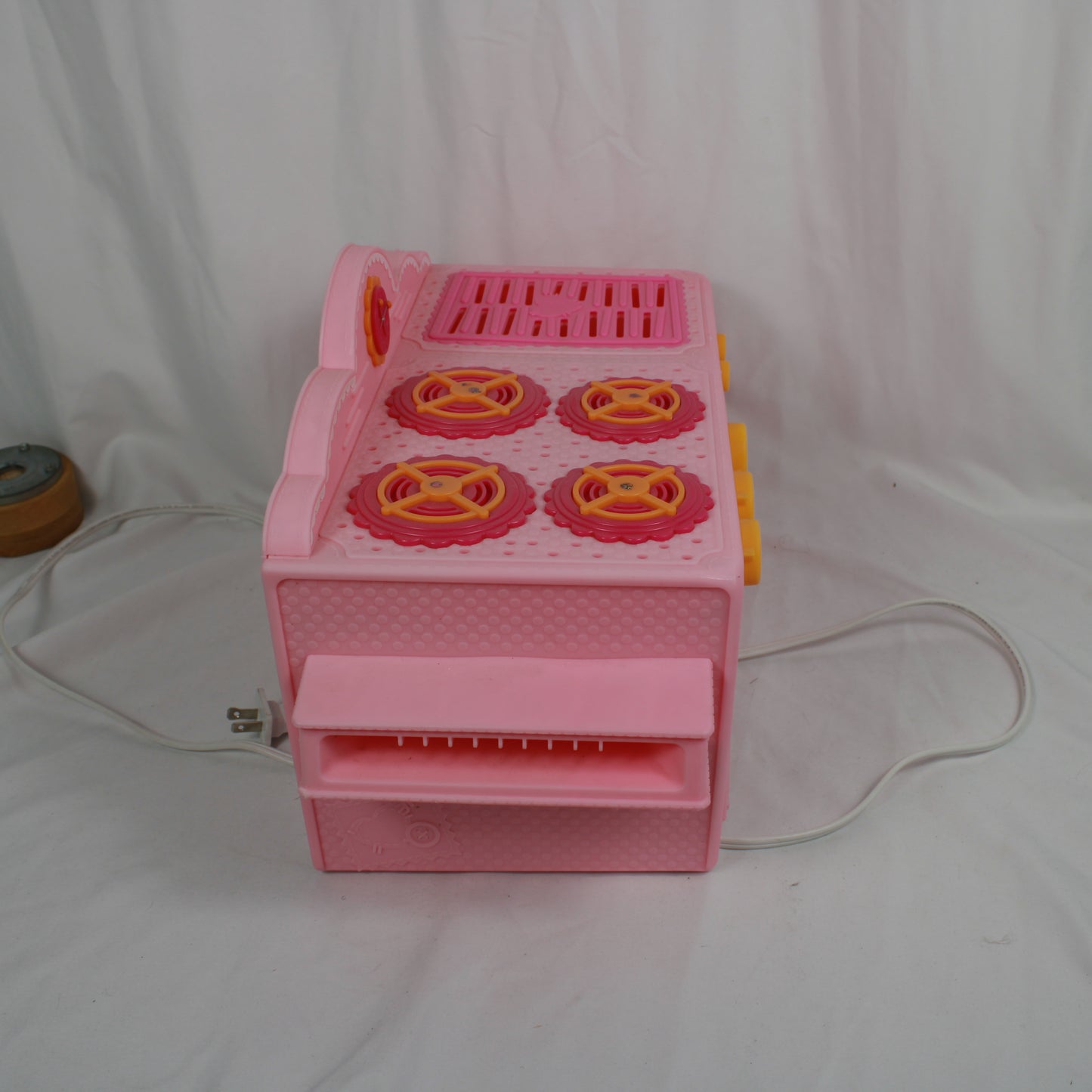 Pink toy cash register on a white background