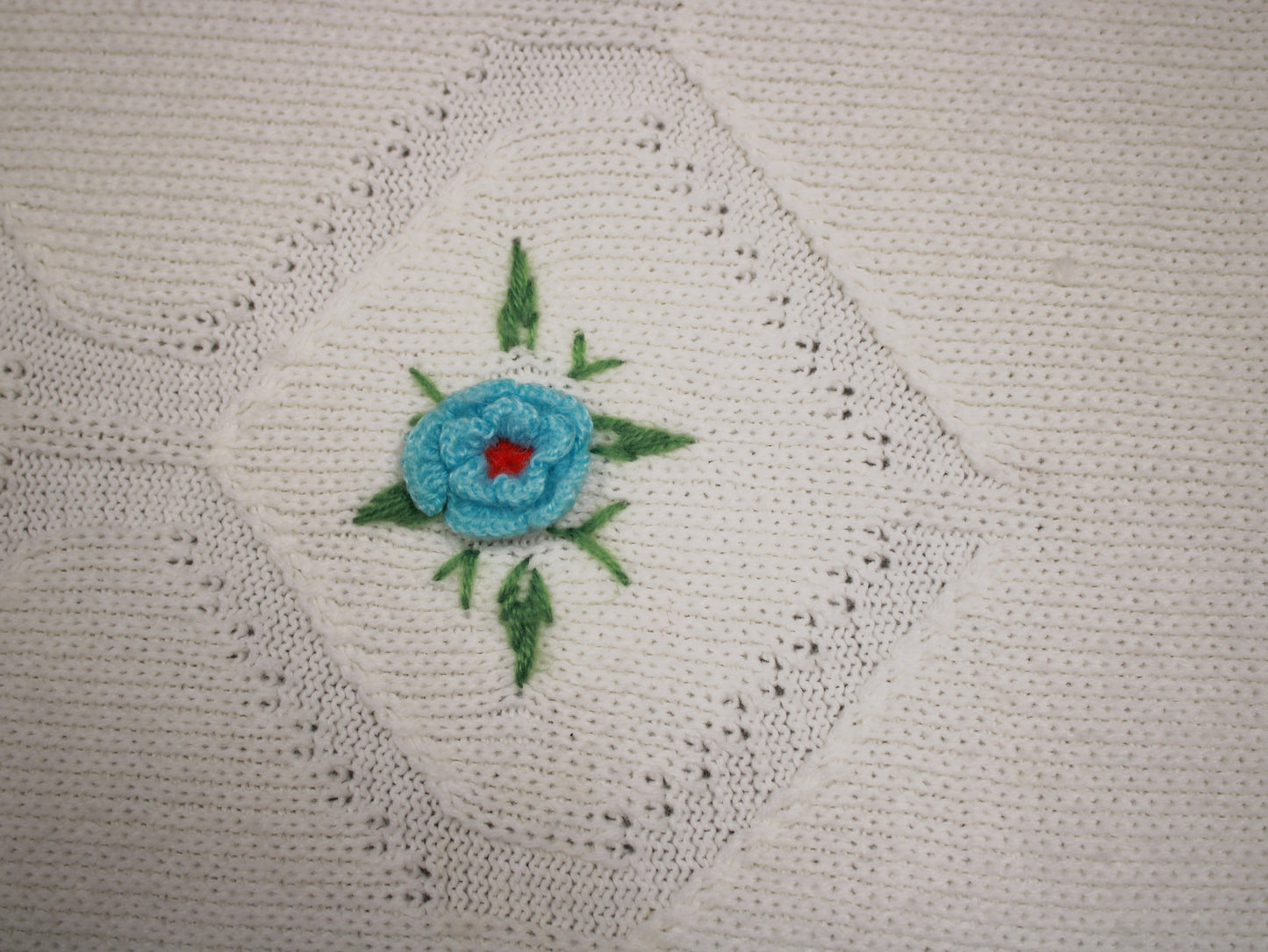 Hand-Knitted White Baby Blanket with Blue Floral Embroidery