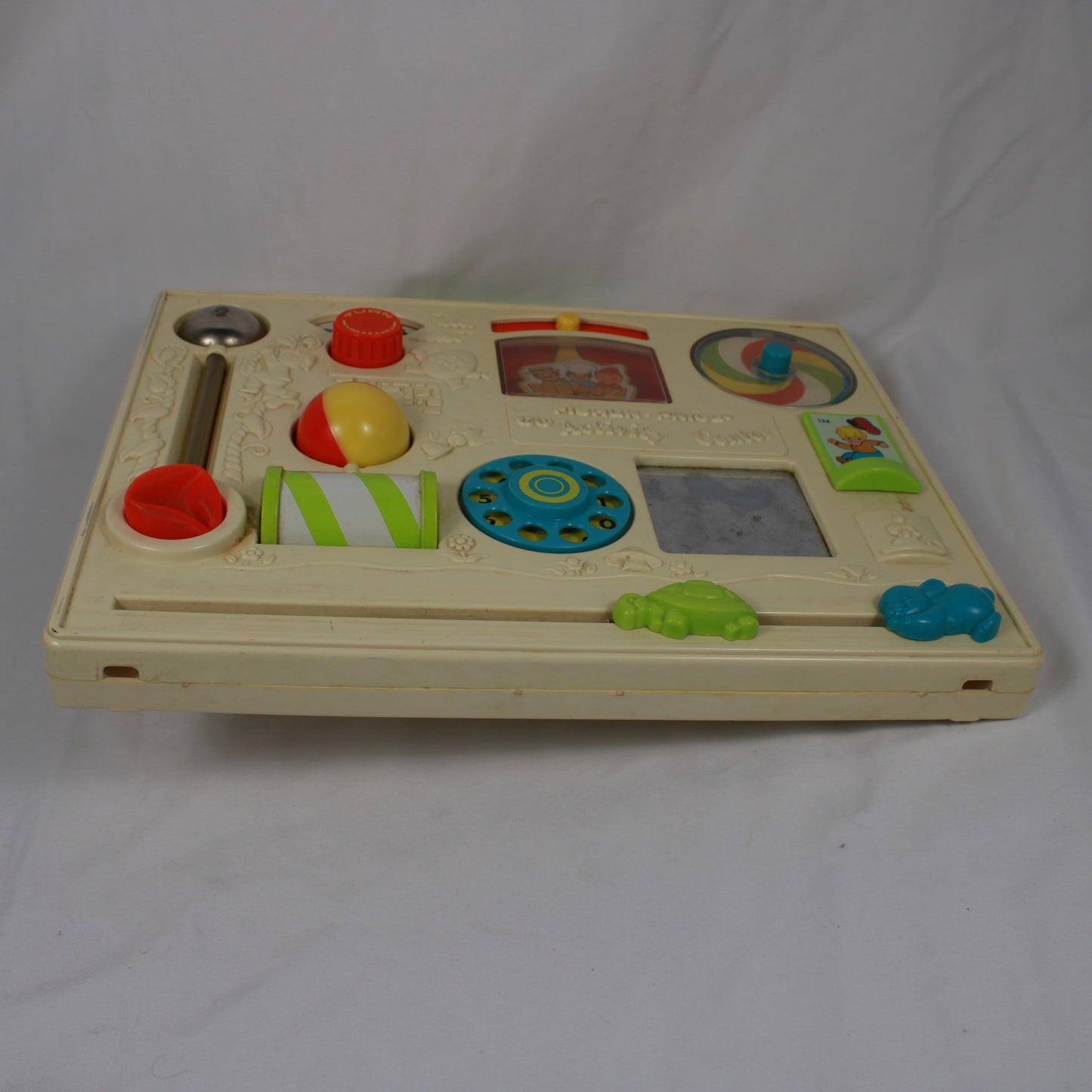 Children's educational toy with various interactive elements on a white background