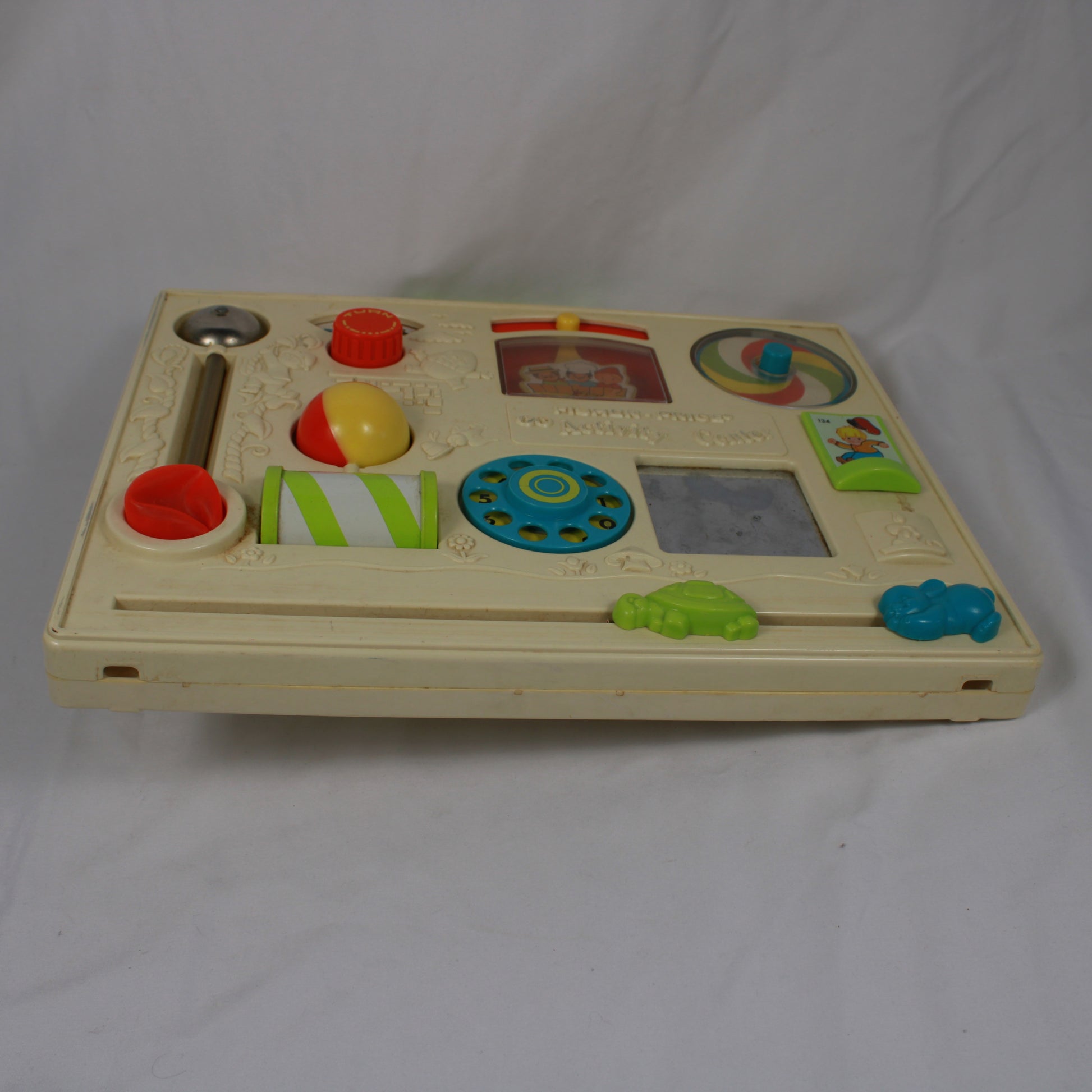 Children's educational toy with various interactive elements on a white background