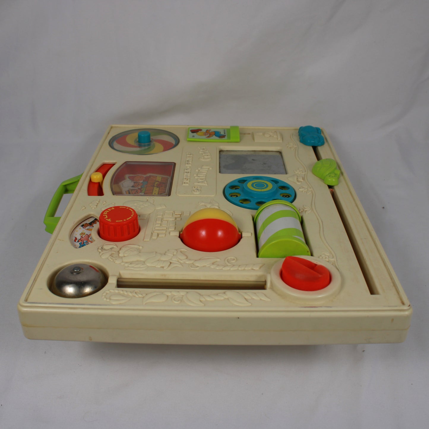Children's educational toy with various interactive elements on a white background