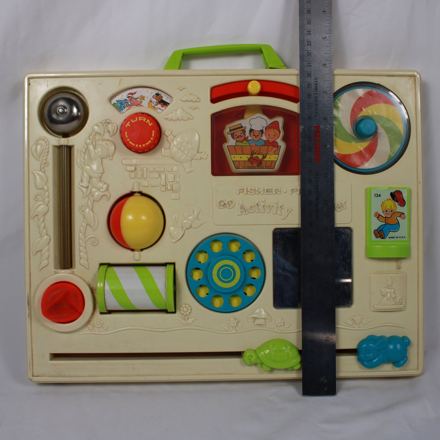 Vintage children's activity book with colorful buttons and a ruler for scale on a white background