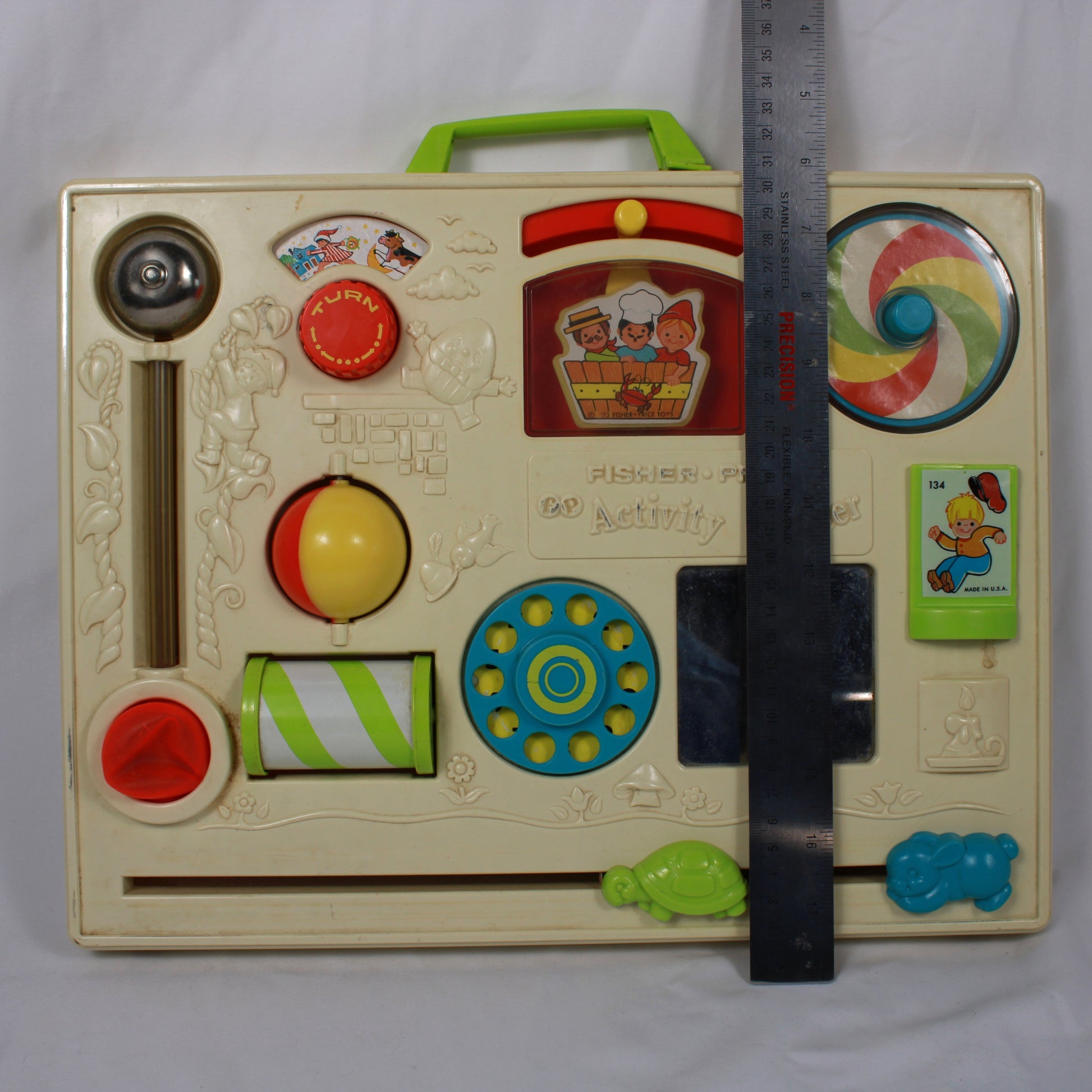 Vintage children's activity book with colorful buttons and a ruler for scale on a white background