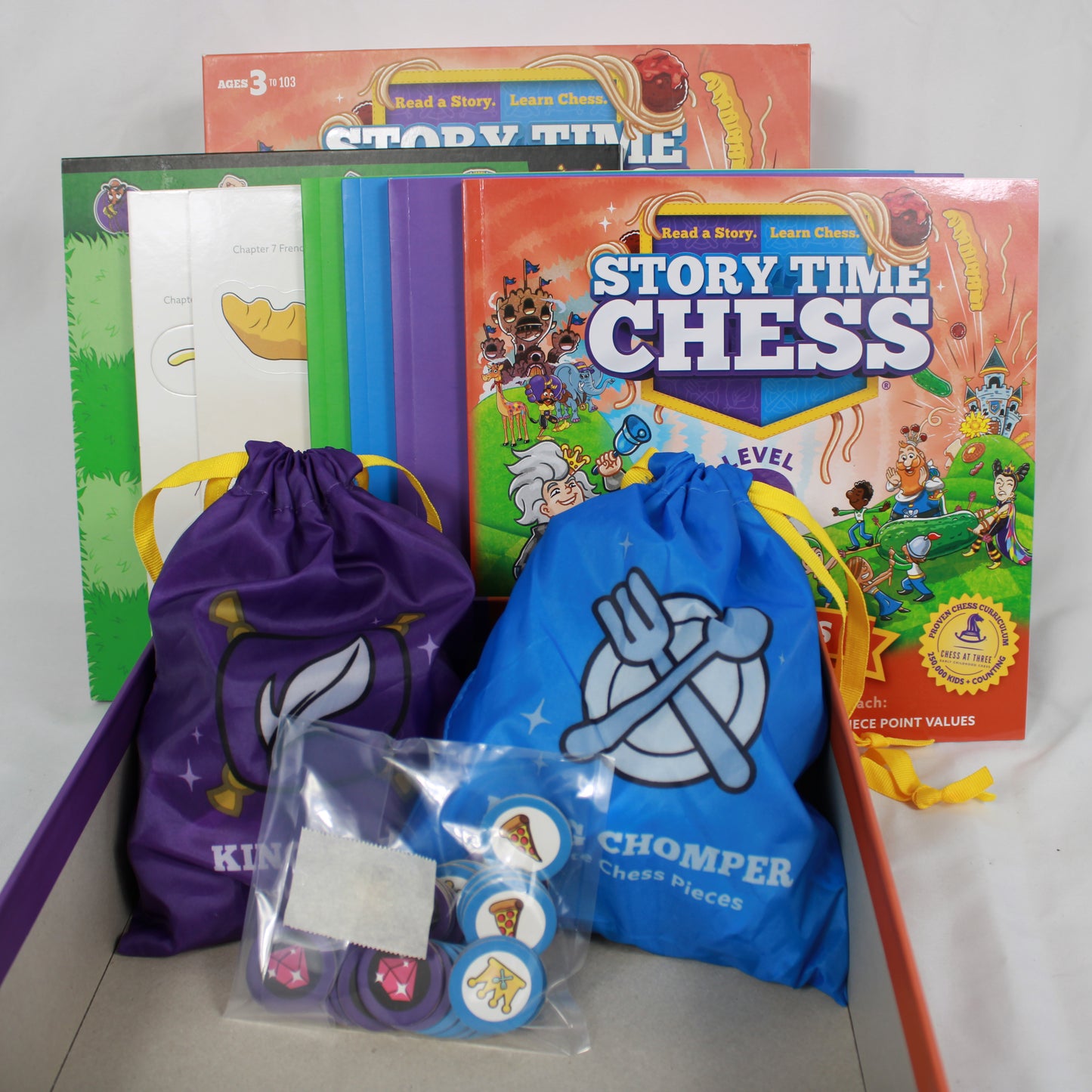 Educational materials including books and bags with branding on a white background