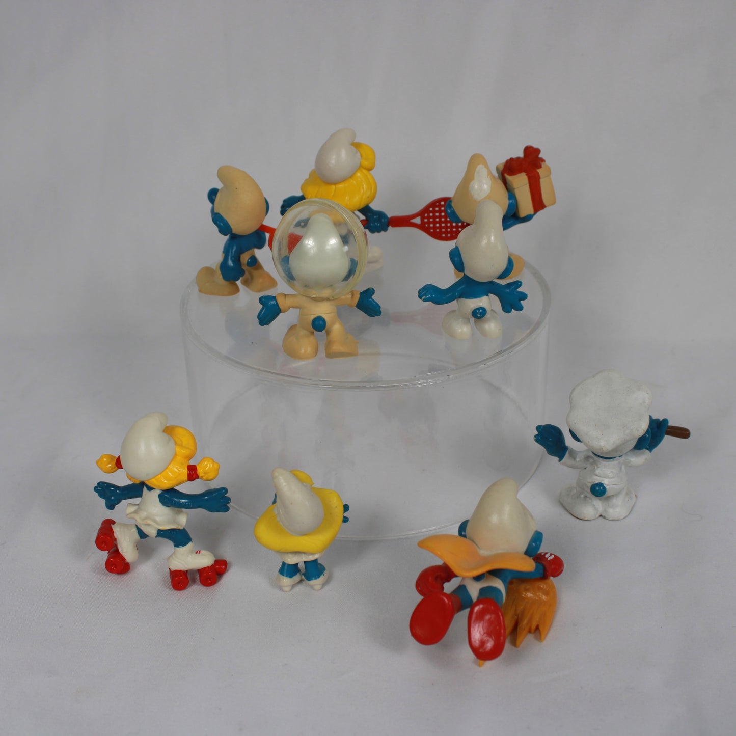 Set of Smurf figurines with various poses on a white background