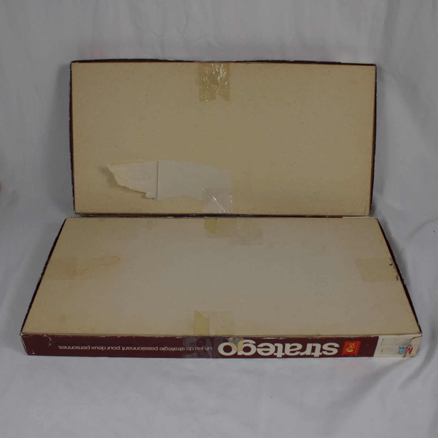 Vintage 'Stratego' board game box with visible wear on a white background