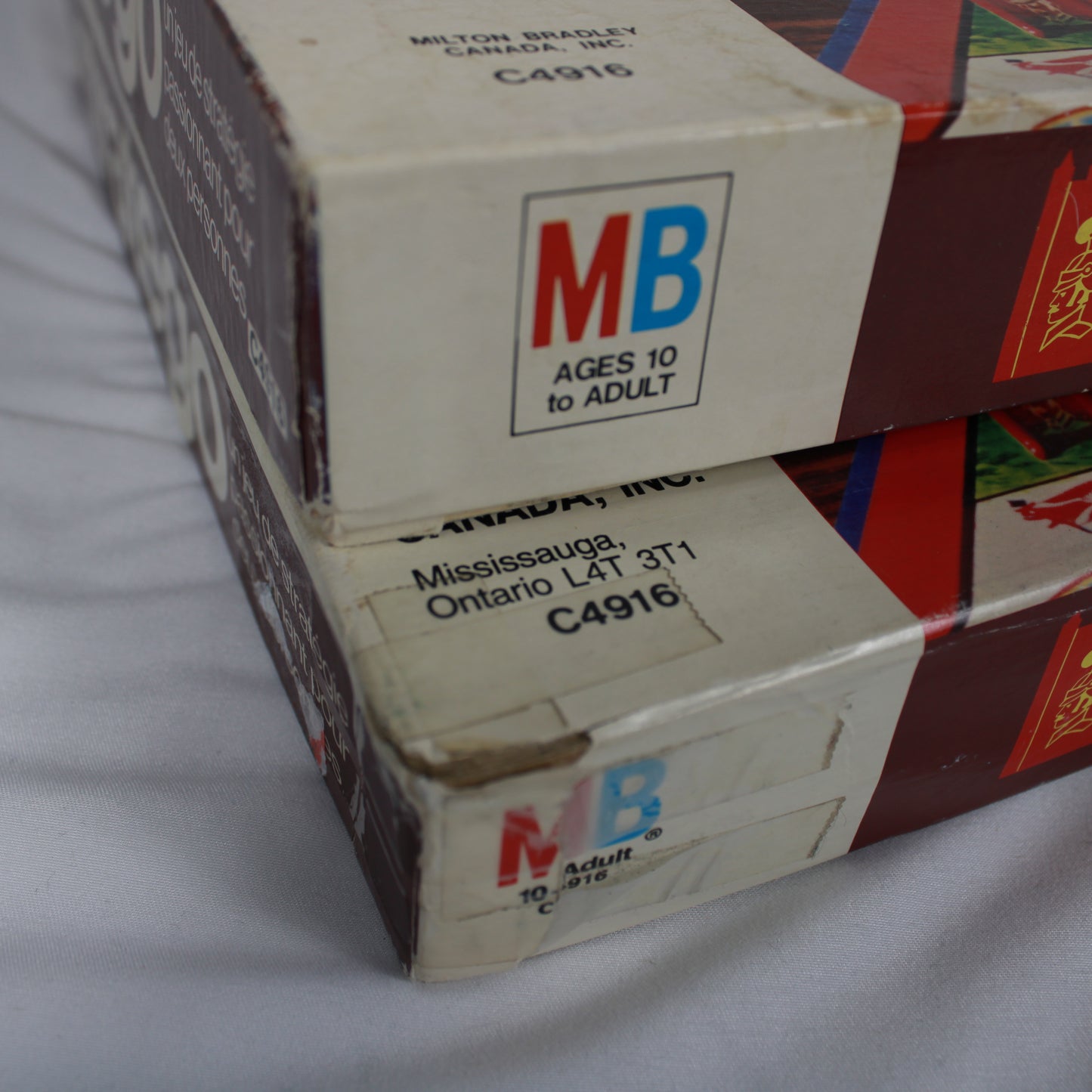 Close-up of a Milton Bradley game box with branding and text.
