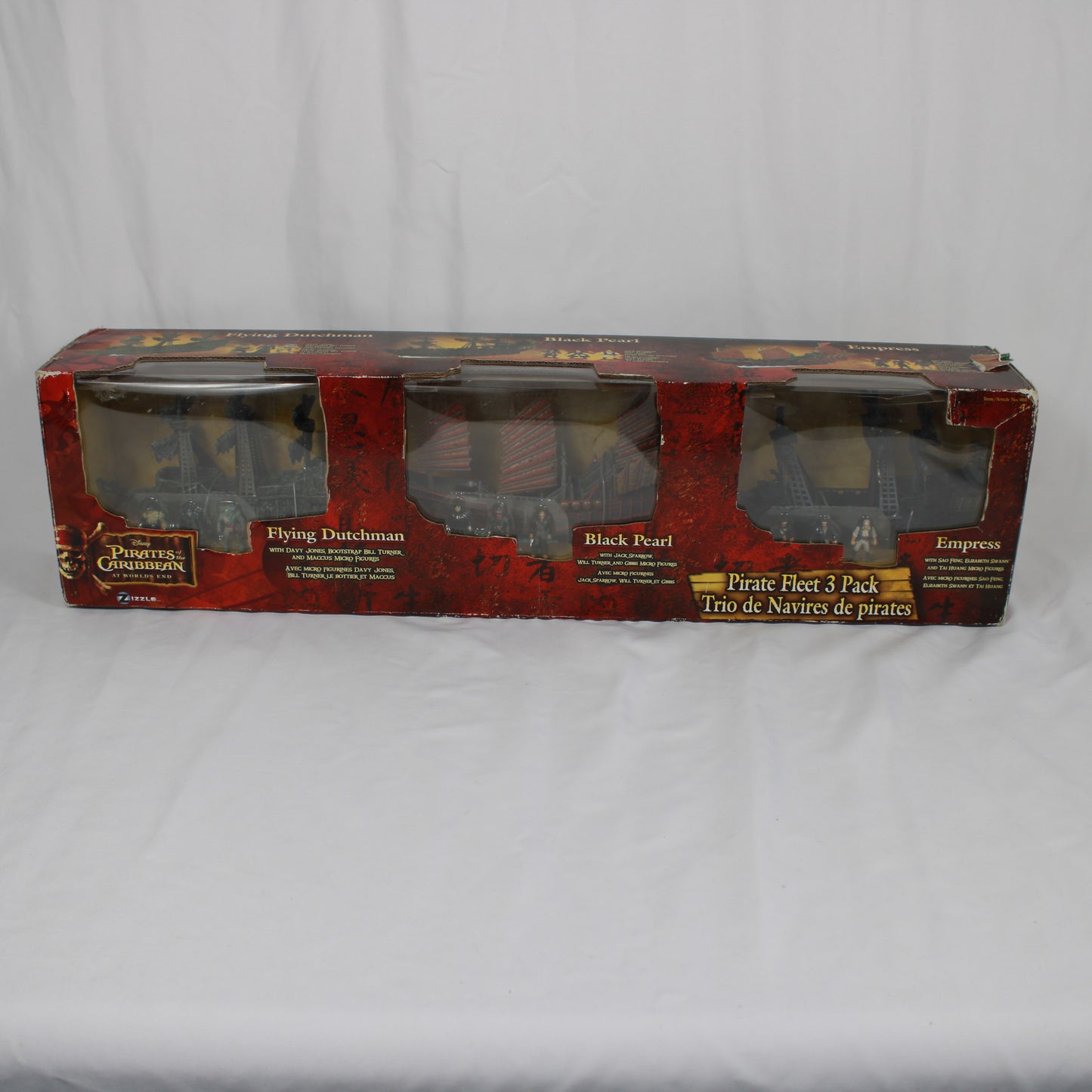 Box of 'Pirates of the Caribbean' pirate ship models on a white background