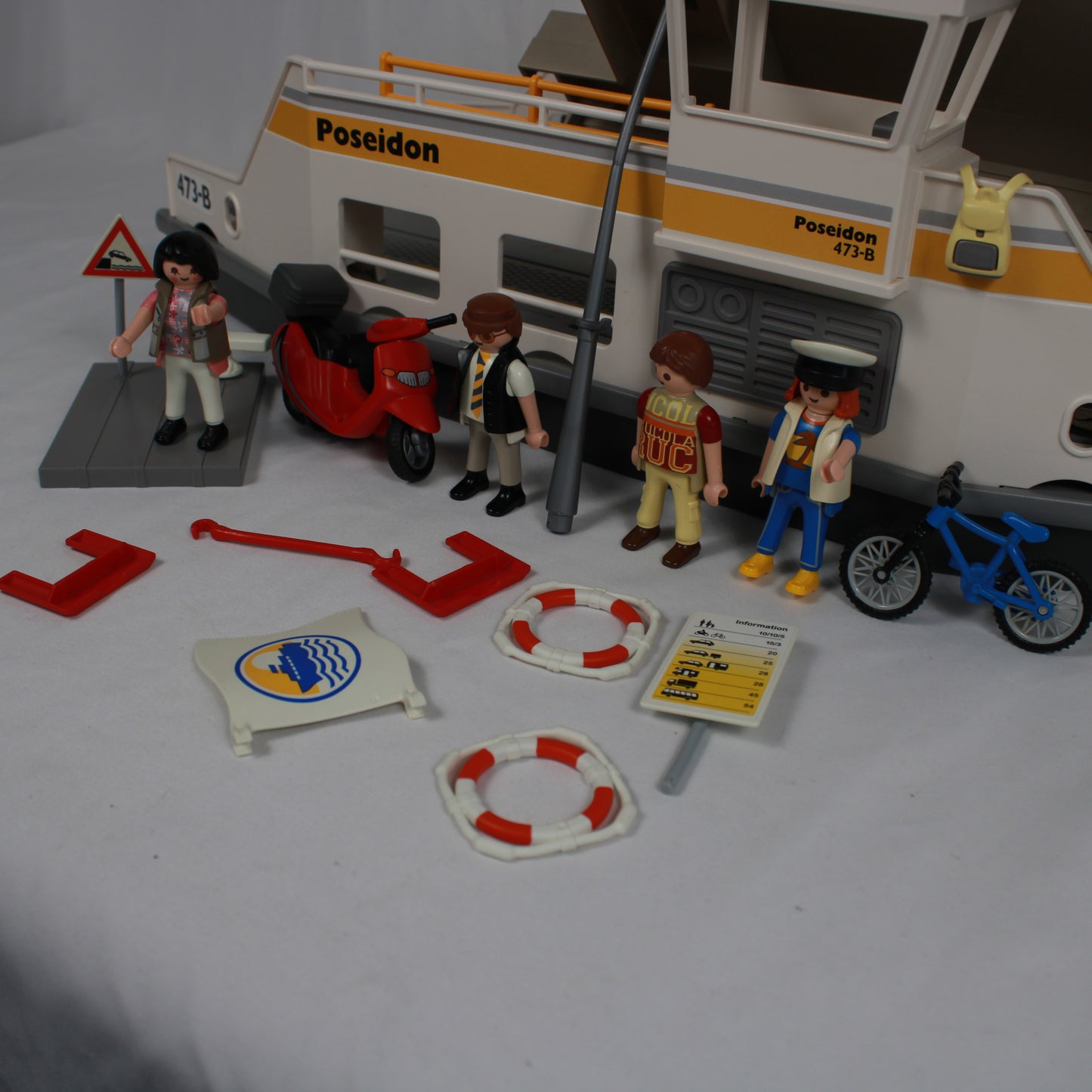 Toy set with a boat labeled 'Poseidon', figures, and accessories on a white background