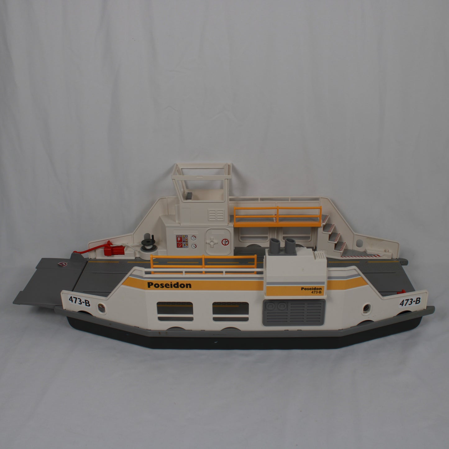 Model of a ferry boat with 'Poseidon' branding on a gray background