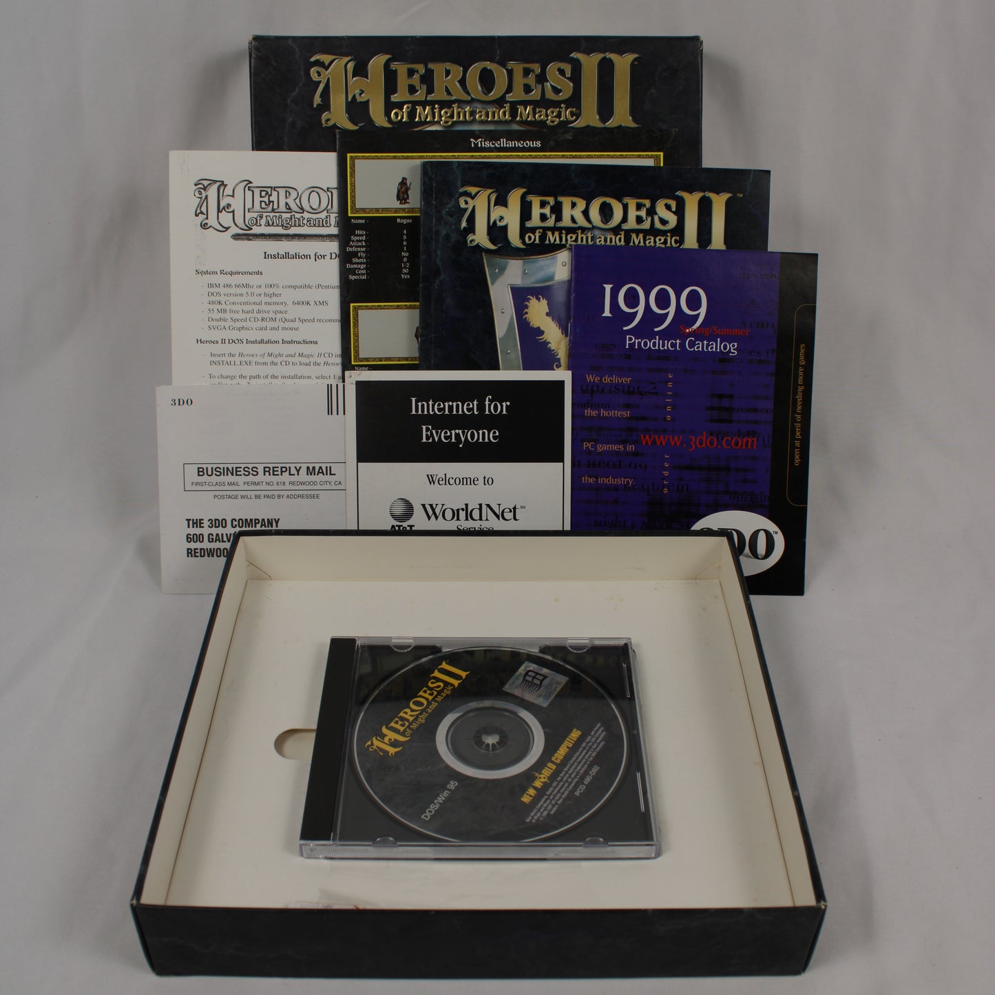 Collection of 'Heroes of Might and Magic II' software packaging and Game Disk on a gray background