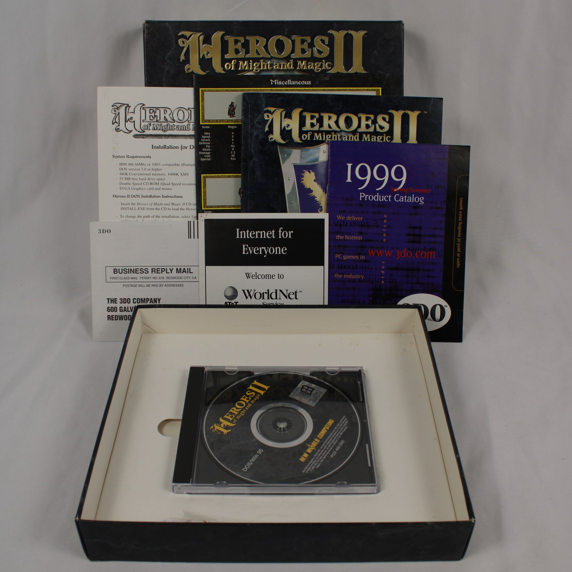 Collection of 'Heroes of Might and Magic II' software packaging and Game Disk on a gray background