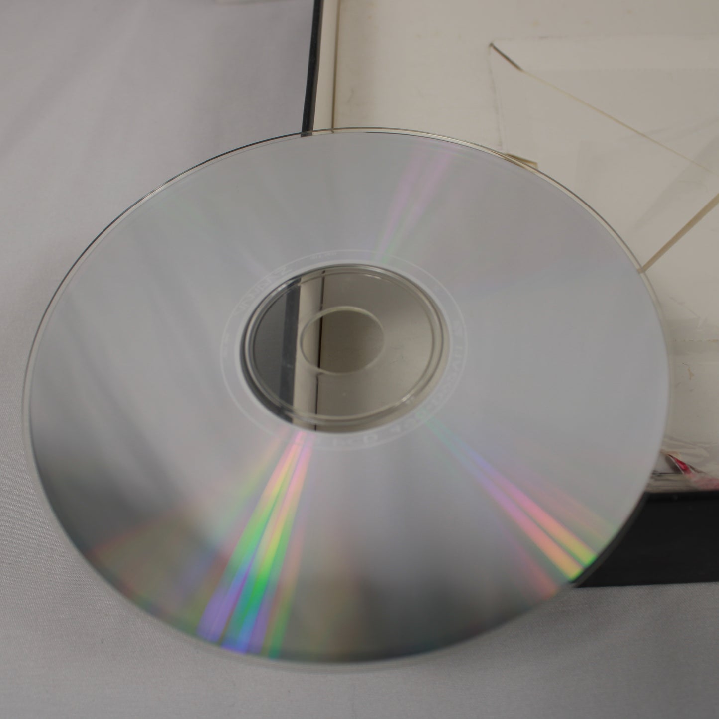 Scratch free disc with rainbow reflection on a white surface