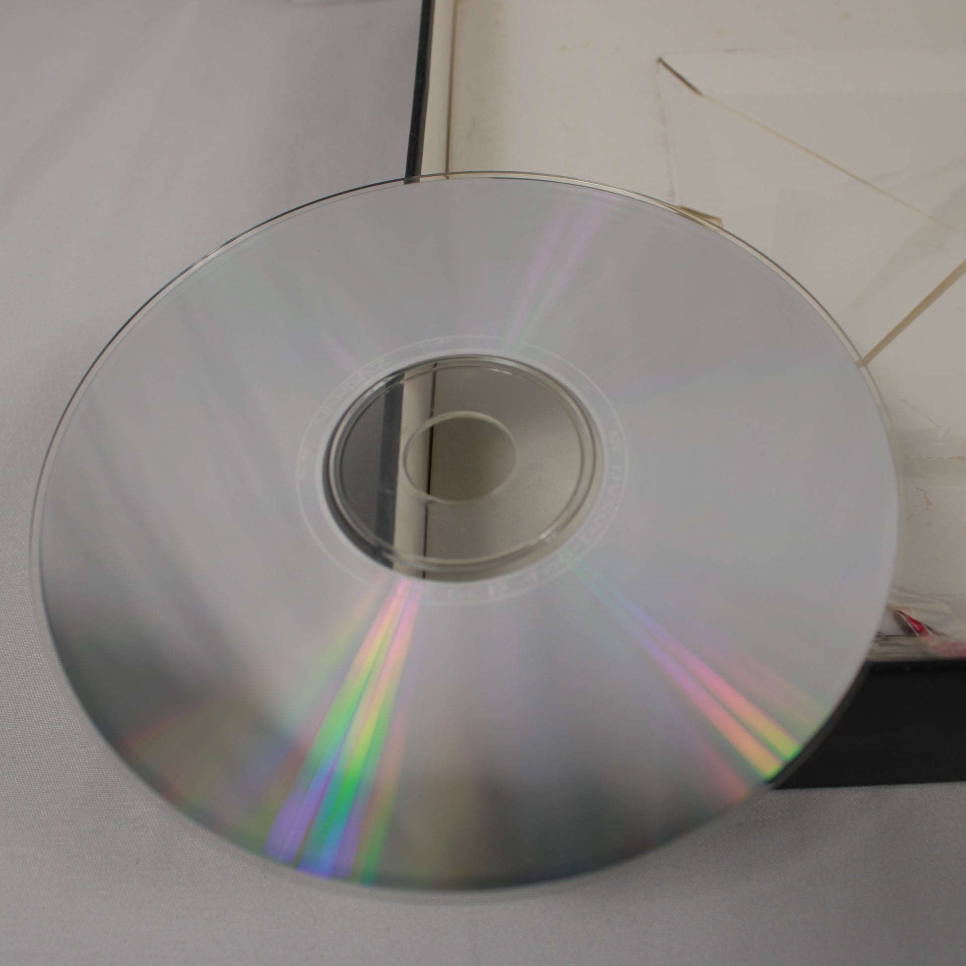 Scratch free disc with rainbow reflection on a white surface