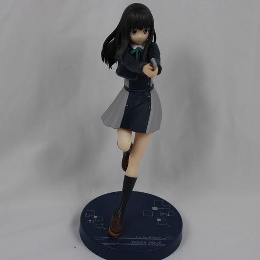 Figurine of a character in a school uniform holding a gun on a gray background