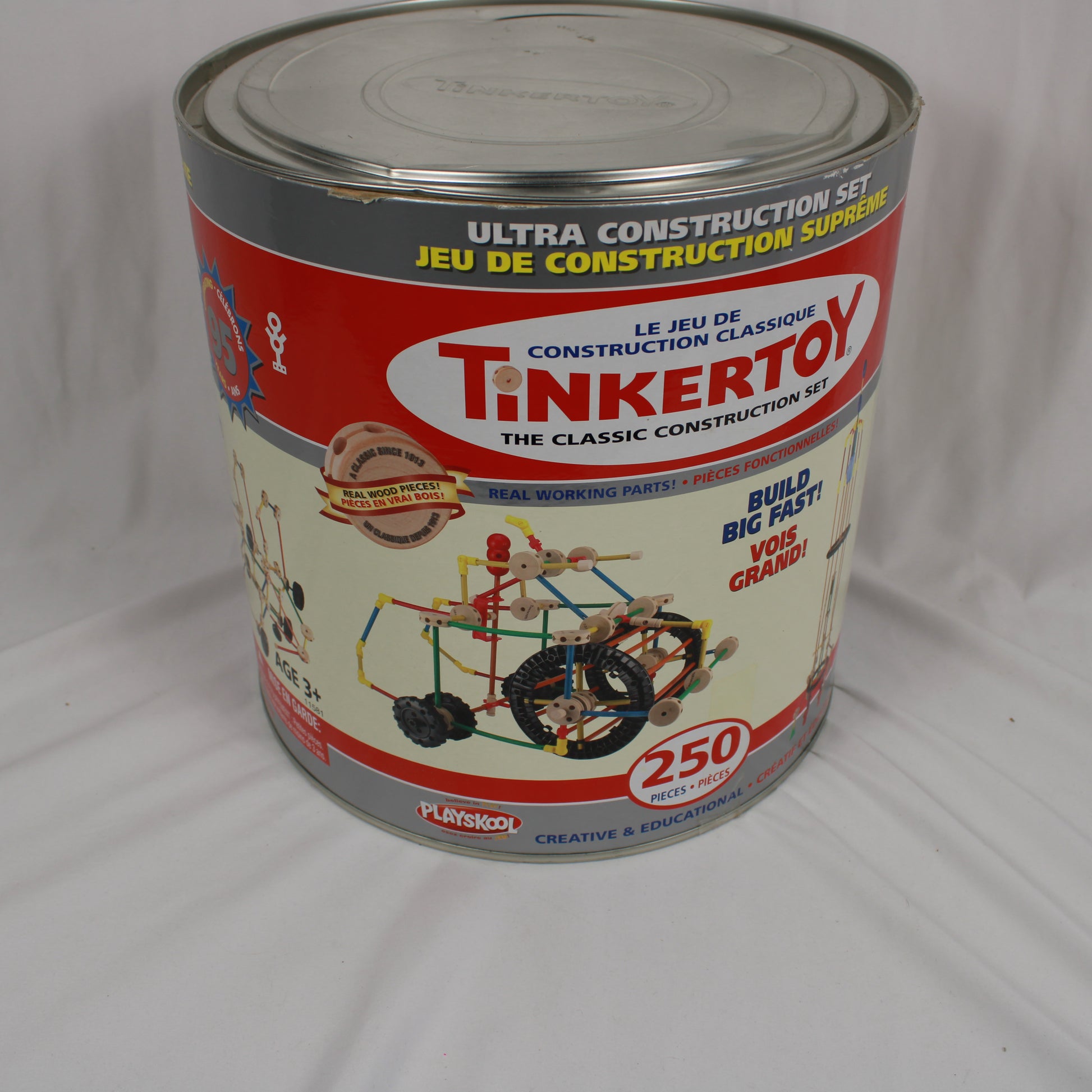 Tinkertoy construction set canister on a plain background