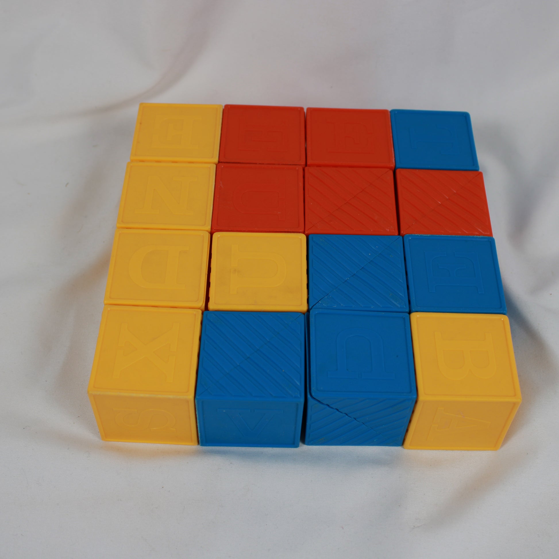 Stack of yellow, red, and blue building blocks on a white background