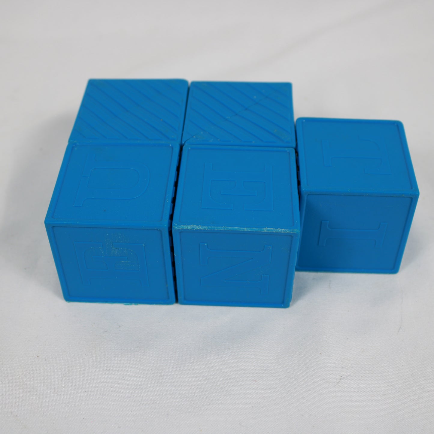 Three blue foam blocks on a gray background