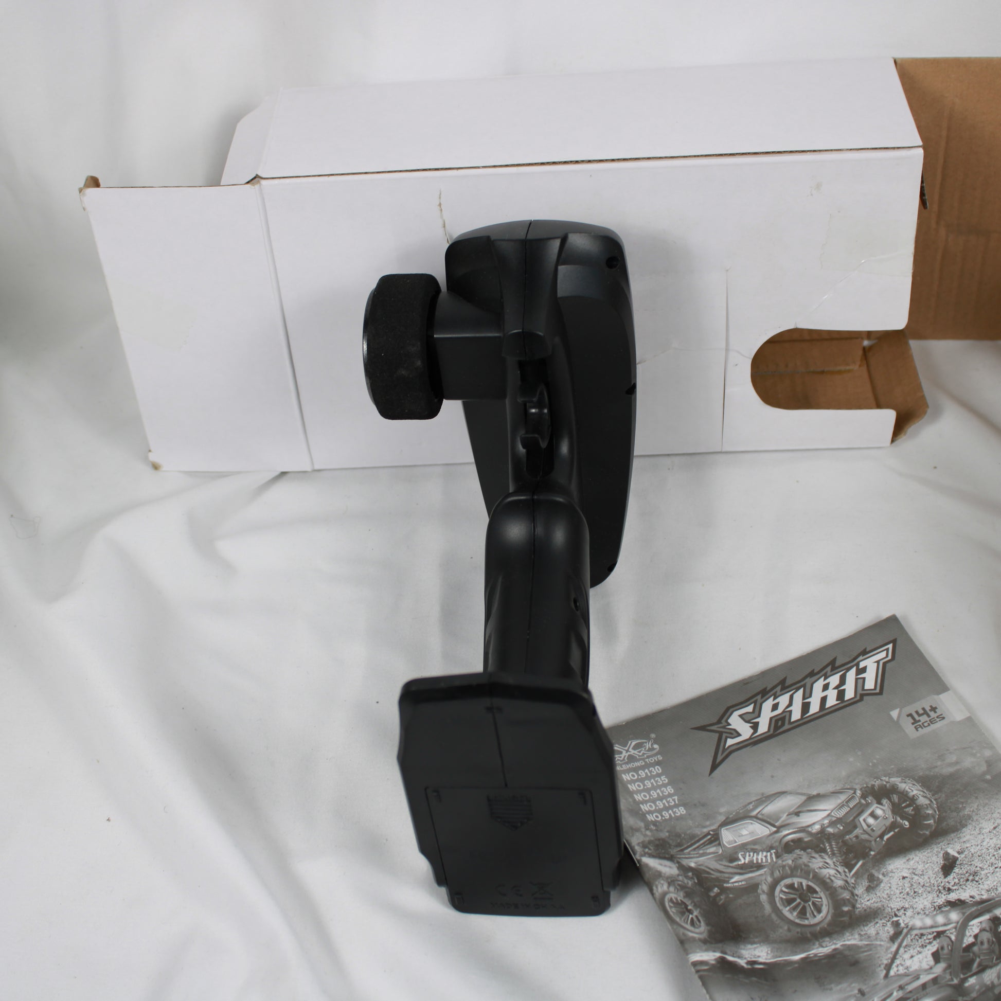 Black car mount on a white surface with a cardboard box and Sprint product packaging.