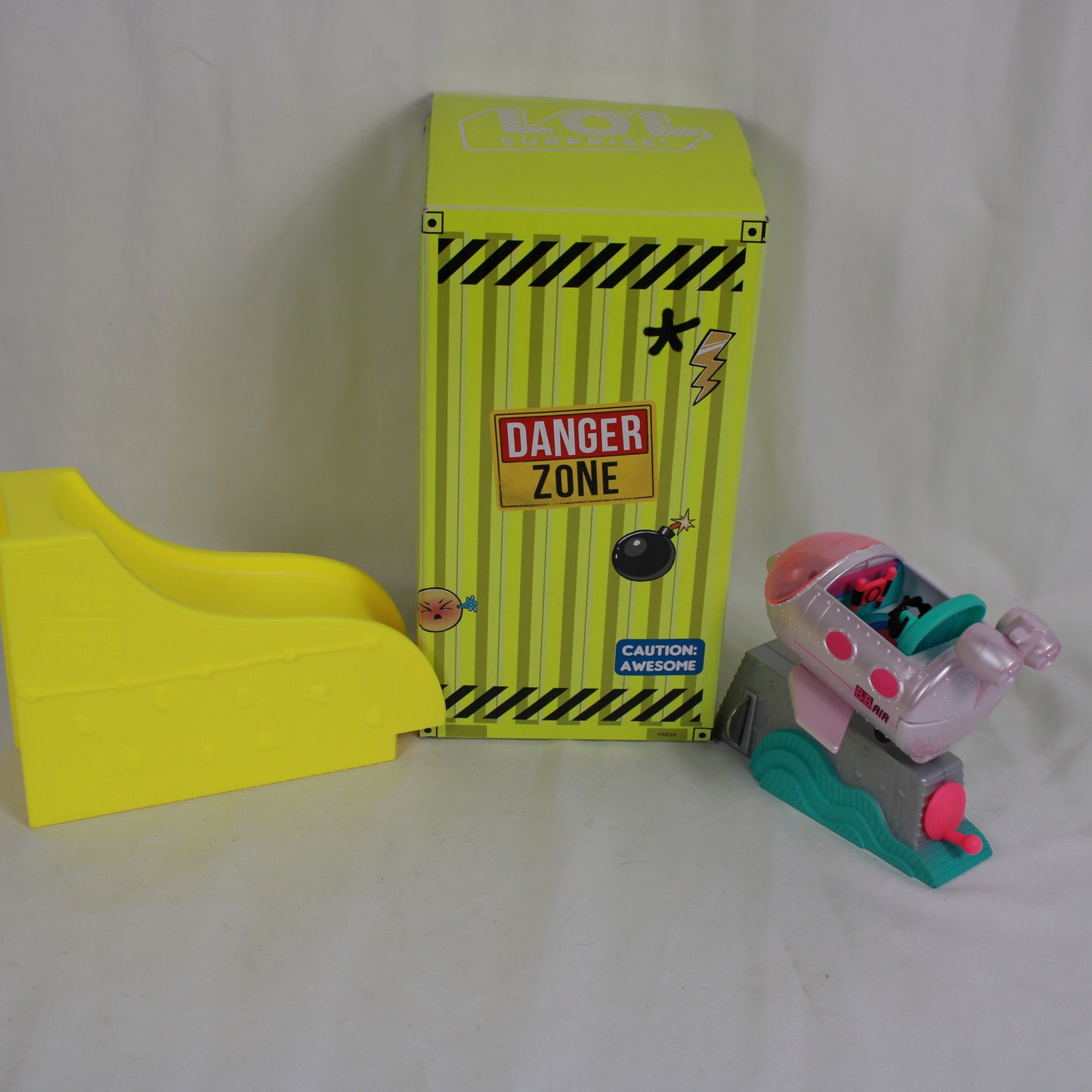 Toy set with a yellow box labeled 'Danger Zone' and a small toy vehicle on a white background