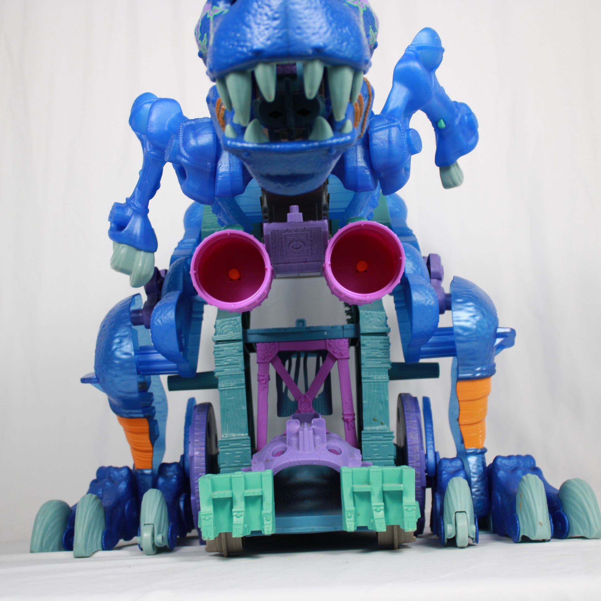 Toy robot with blue, purple, and green colors on a white background