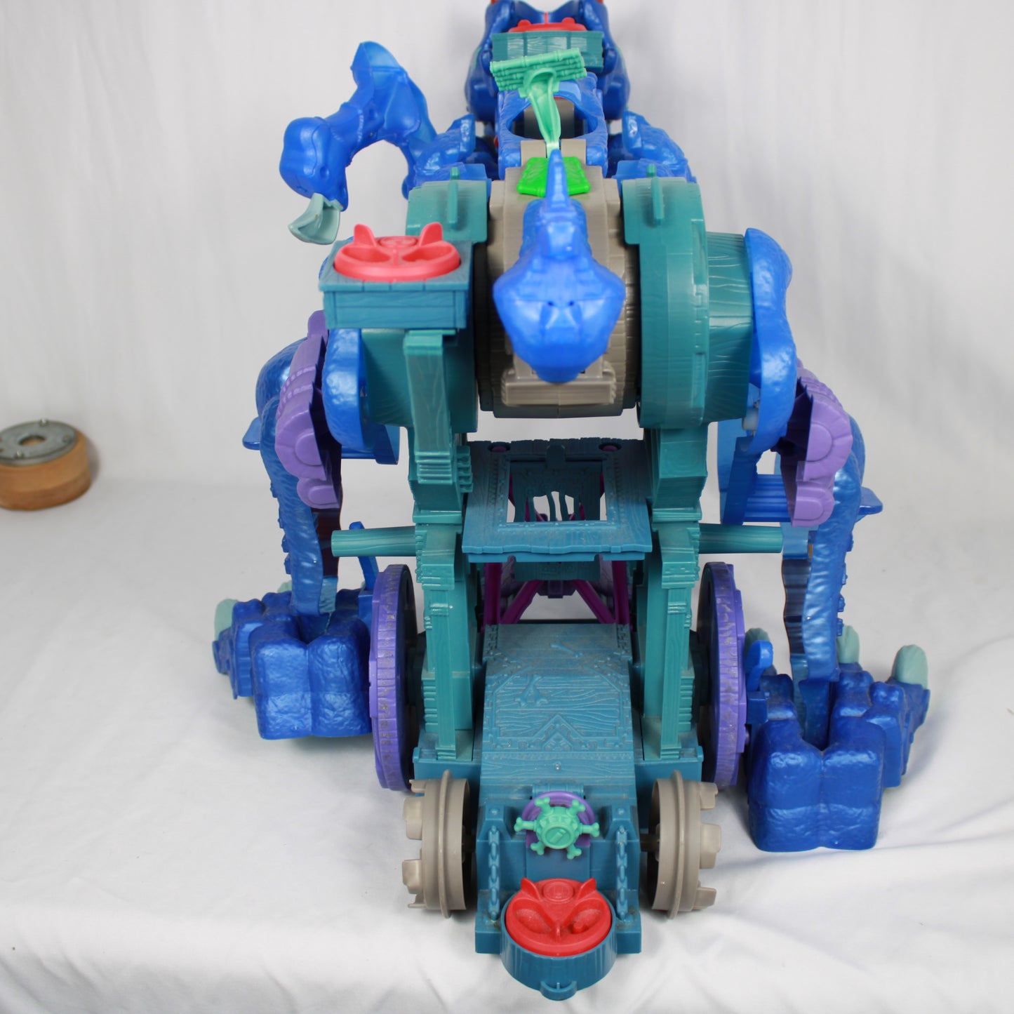 Toy robot with blue, green, and purple colors on a white background