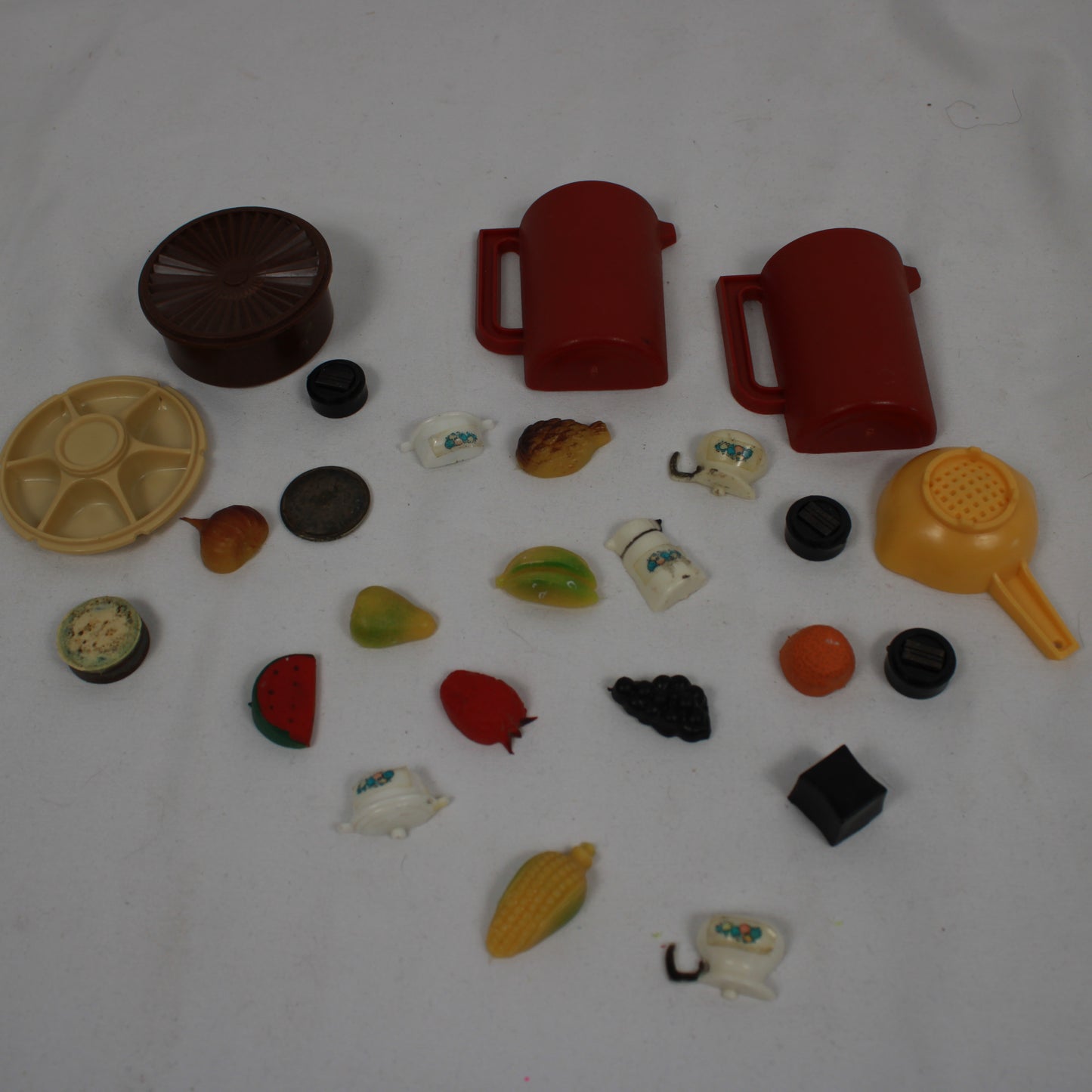 Collection of various plastic toys and items on a white background
