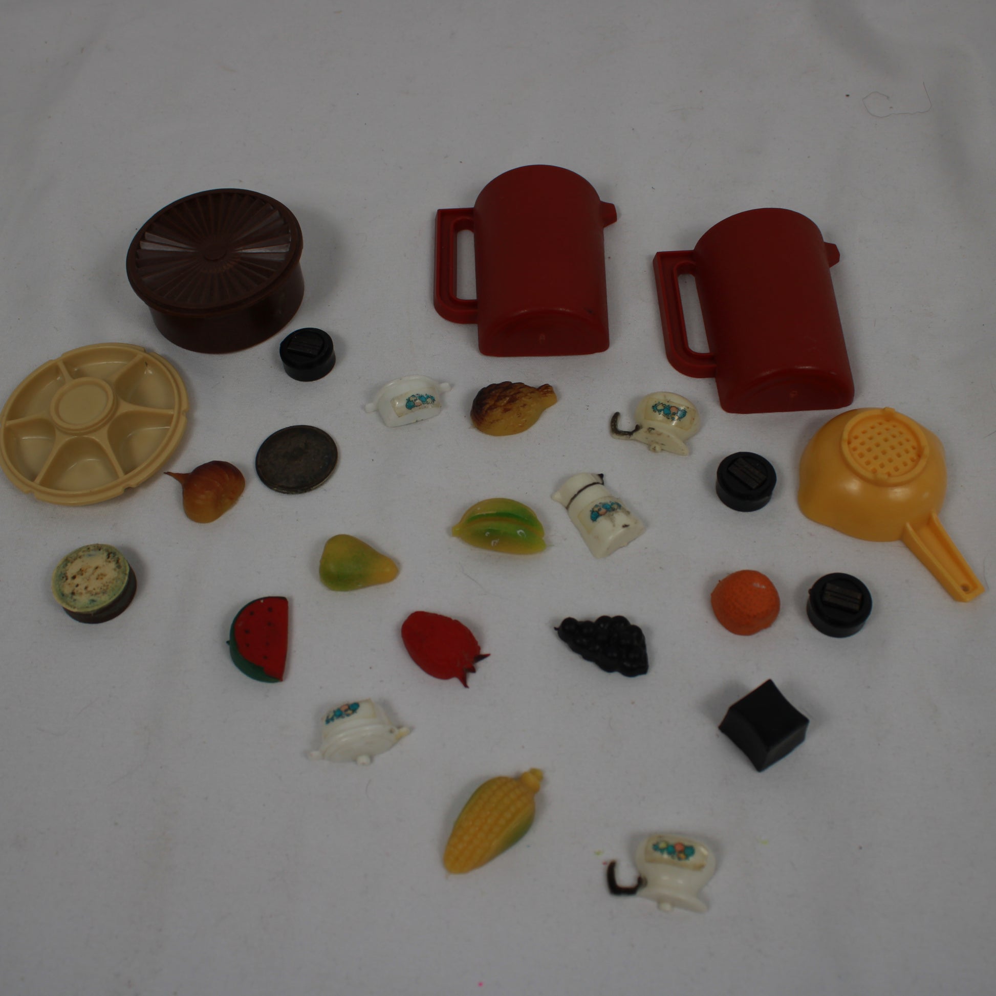 Collection of various plastic toys and items on a white background