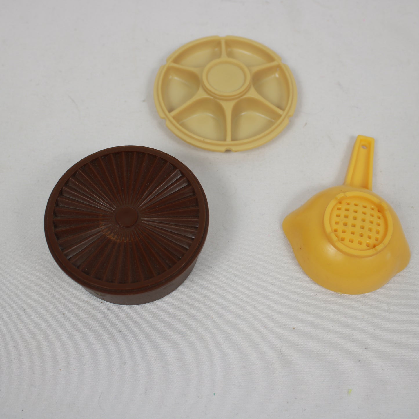 Three plastic components on a white background