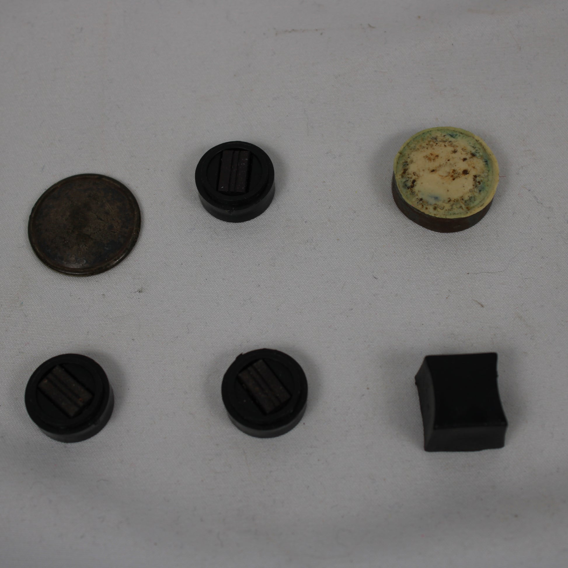 Collection of various black and brown objects on a white surface