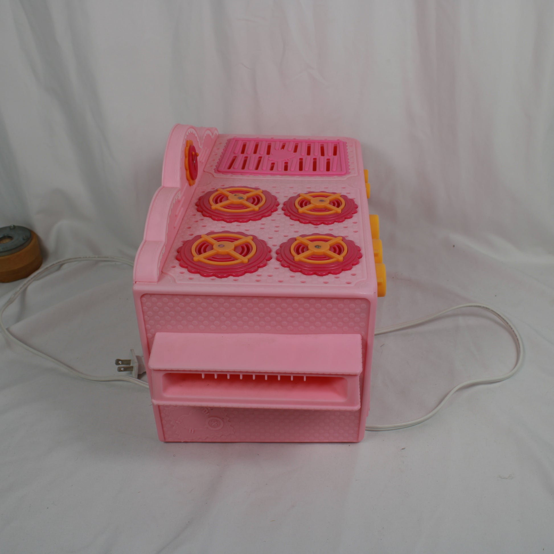 Pink toy cash register on a white background