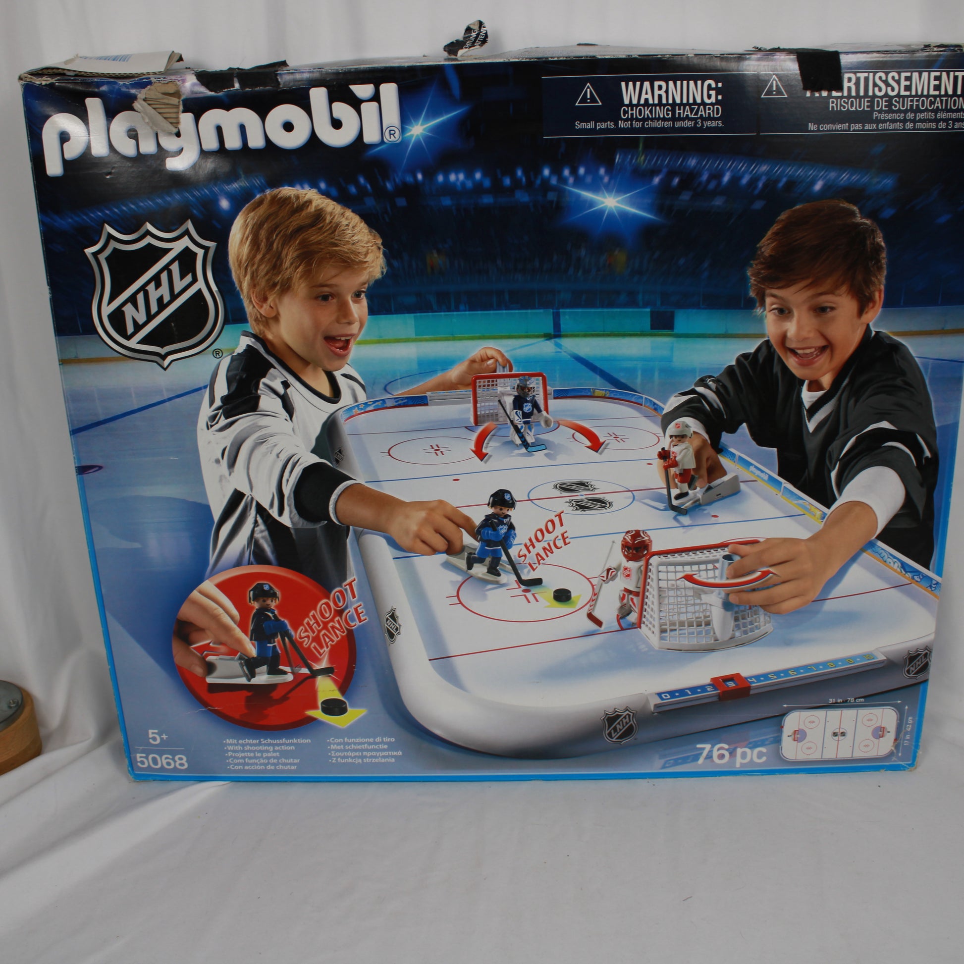 Playmobil NHL hockey set packaging with two children playing on a table.