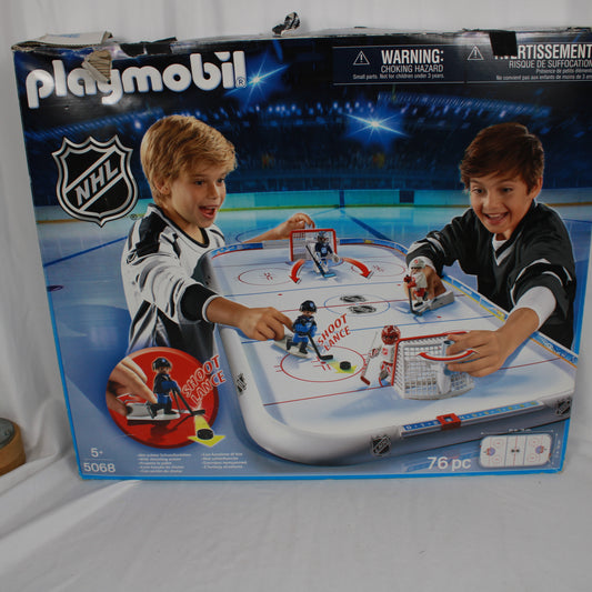 Playmobil NHL hockey set packaging with two children playing on a table.