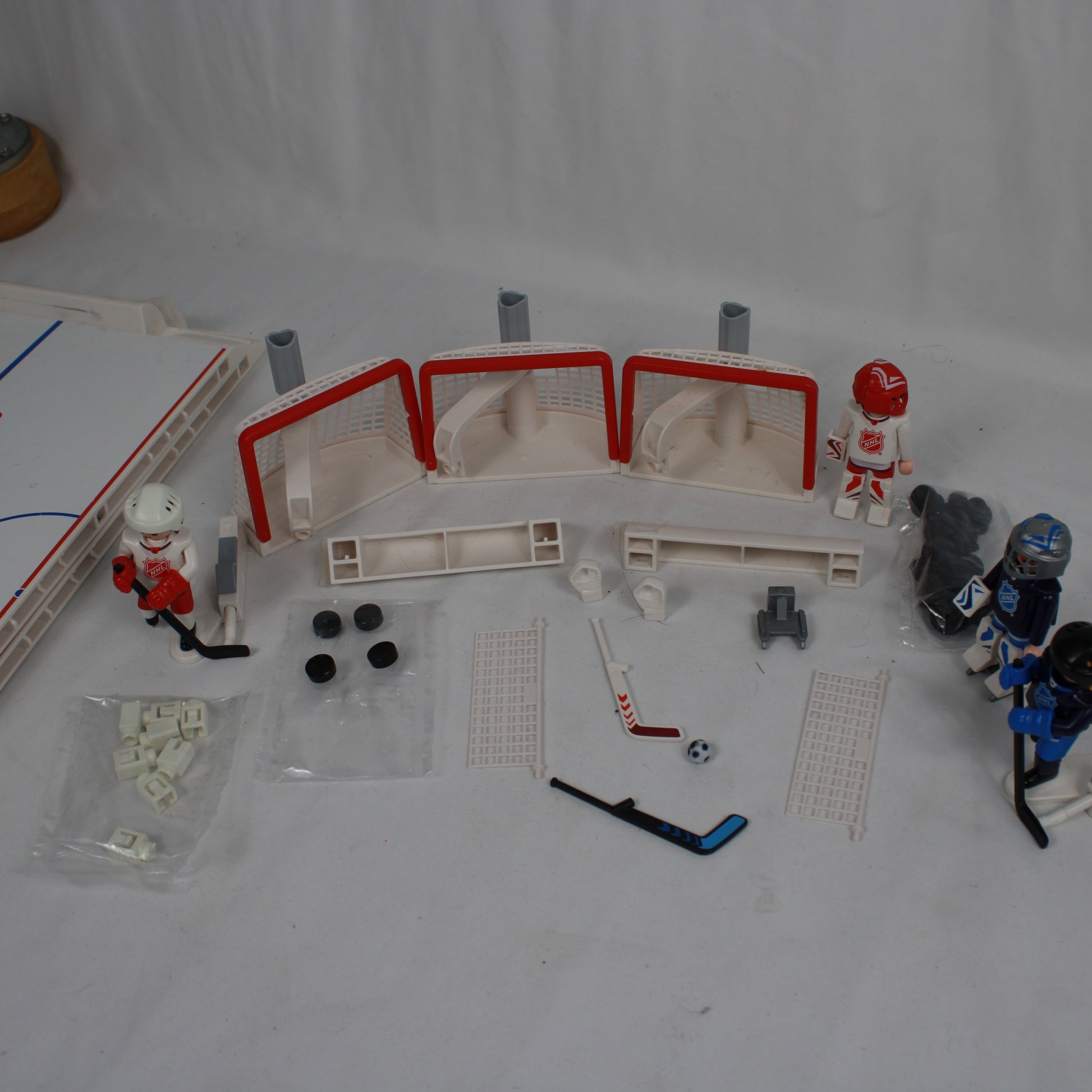 Hockey-themed toy set with figures, equipment, and a miniature rink on a white background