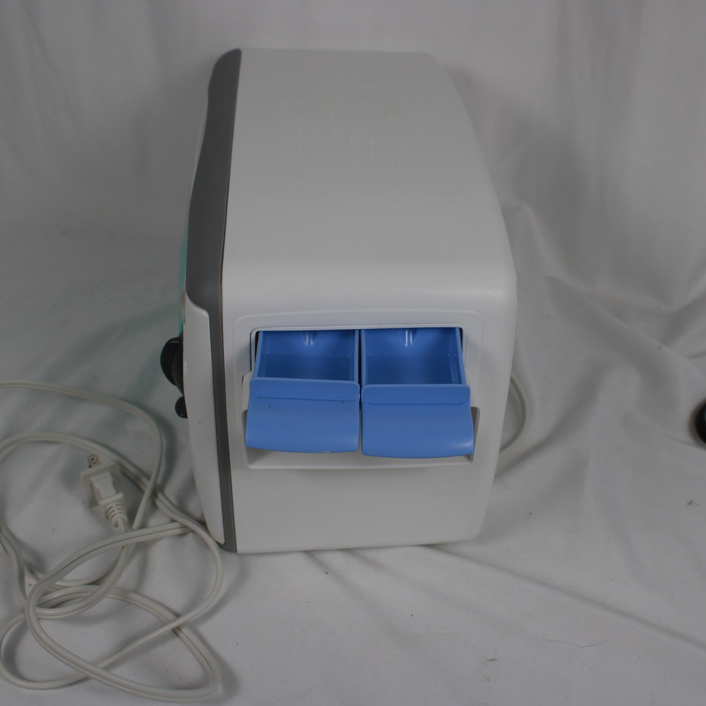 White electronic device with blue drawers on a white background