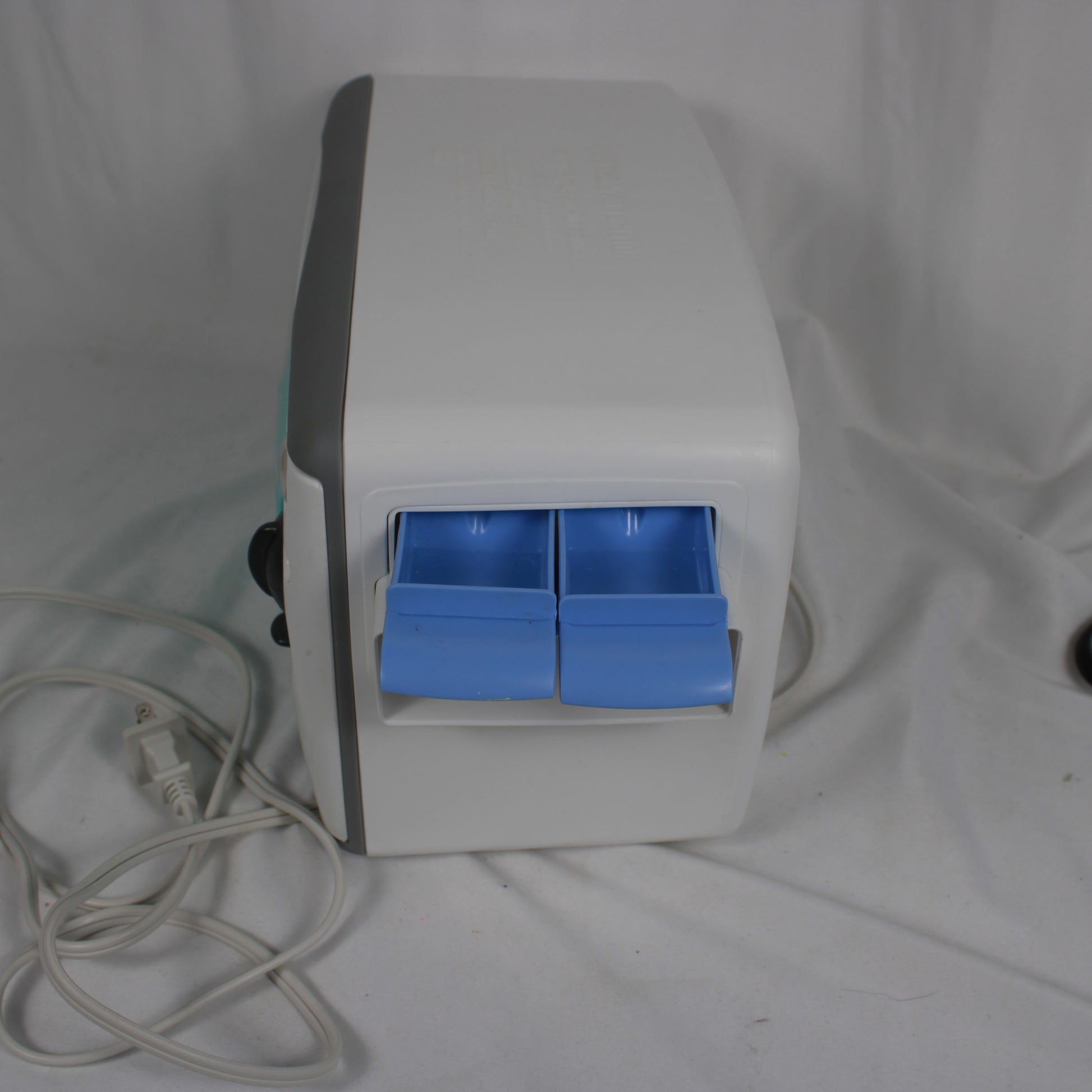 White electronic device with blue drawers on a white background