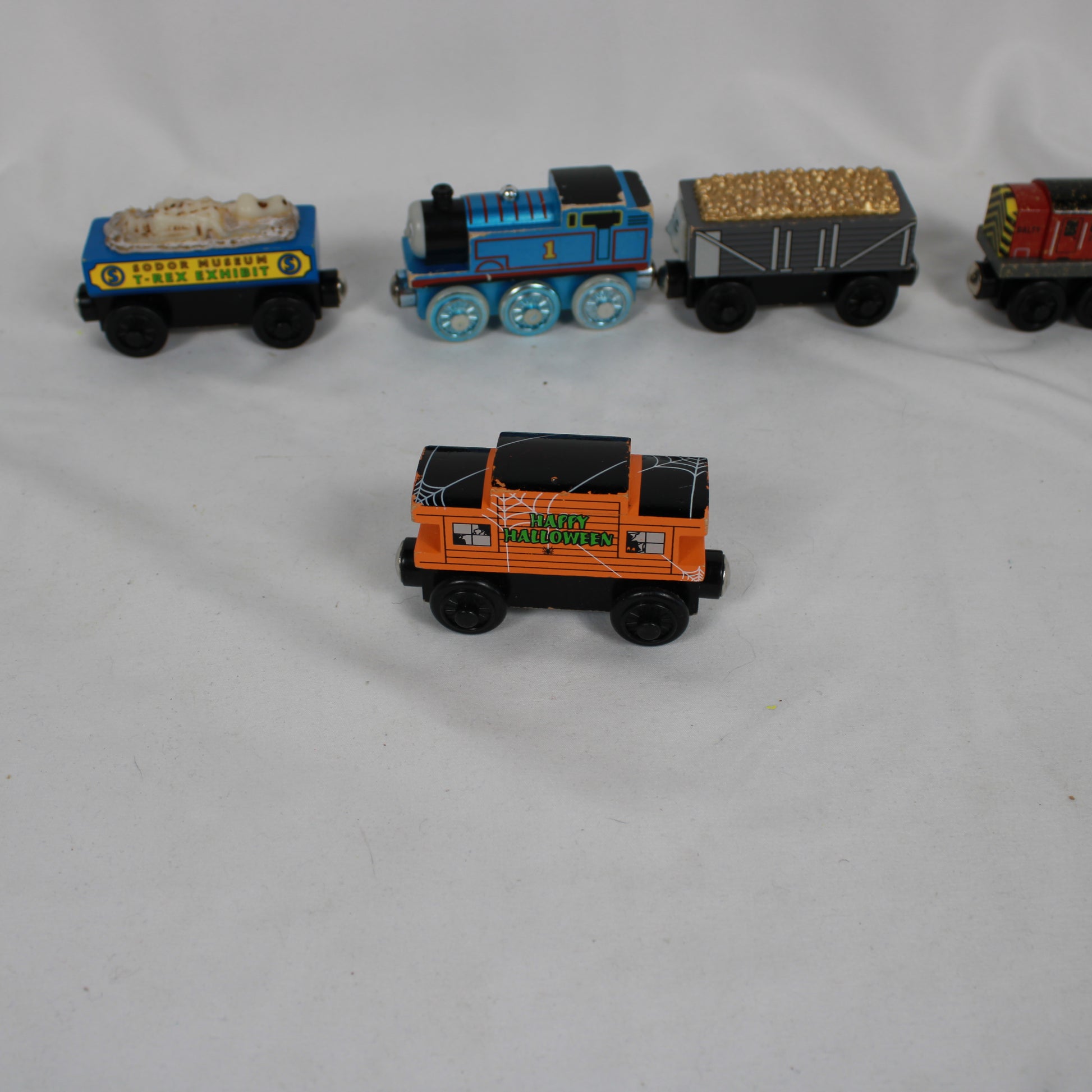 Four toy train cars on a white background