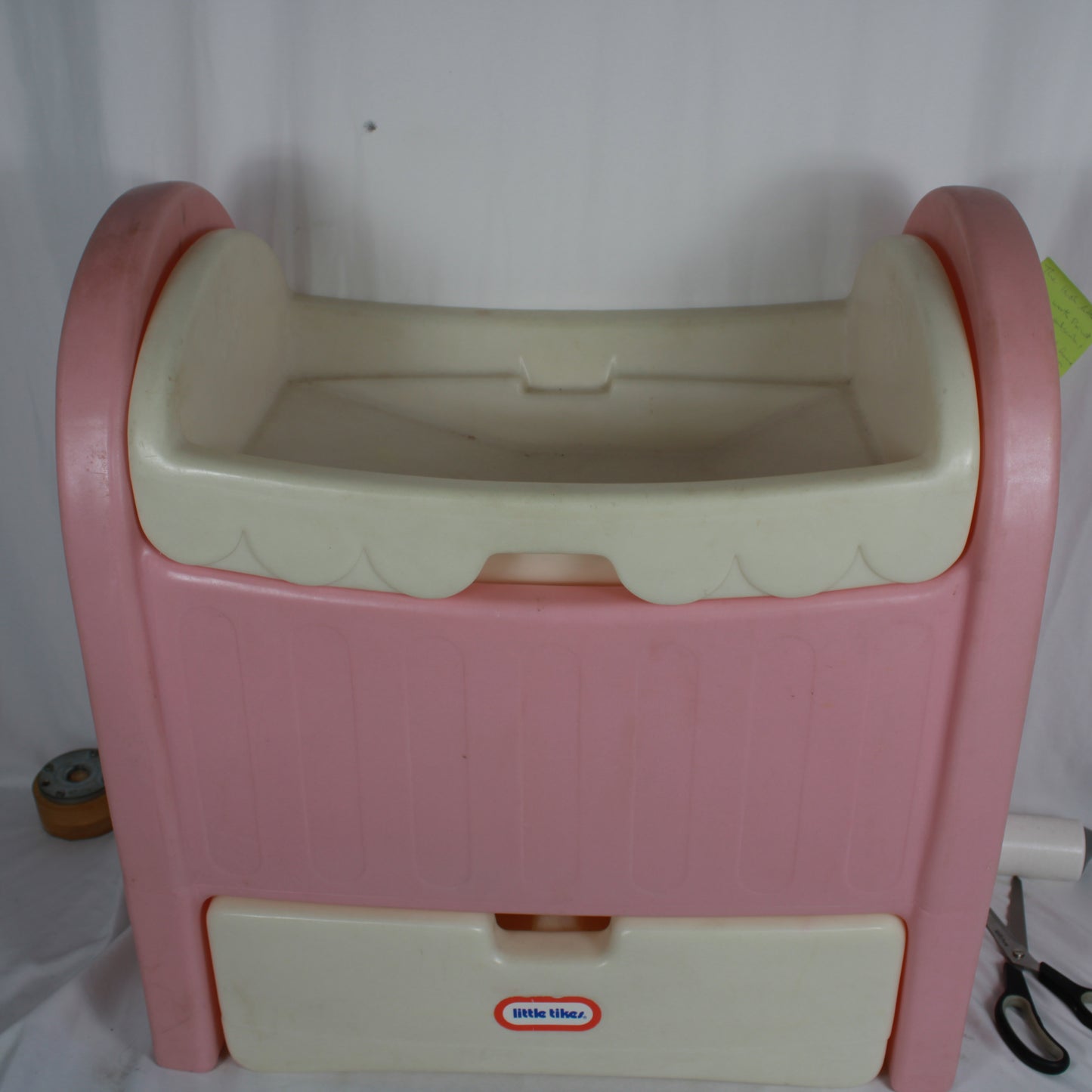 Pink and beige step stool with a visible brand logo on a white background