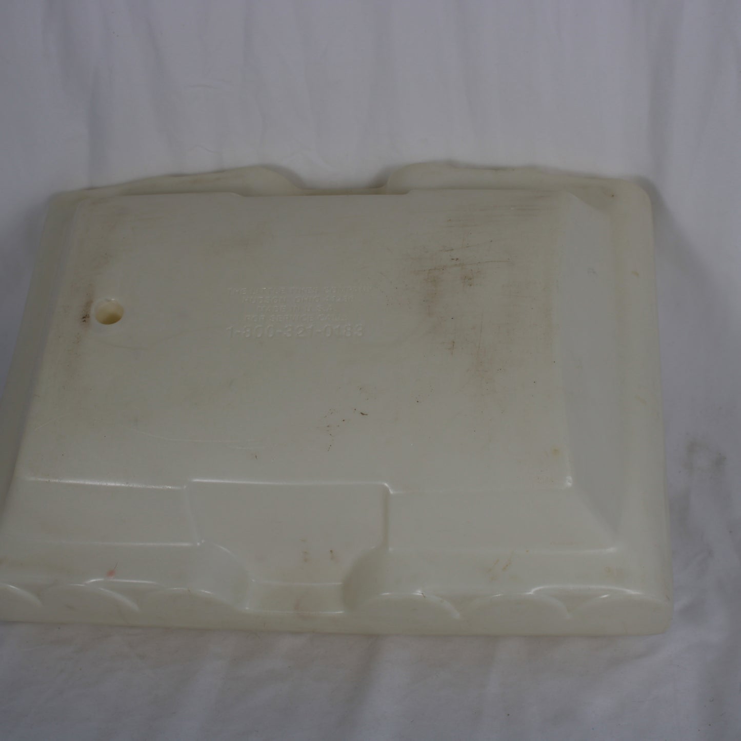 Dirty white plastic container on a white background