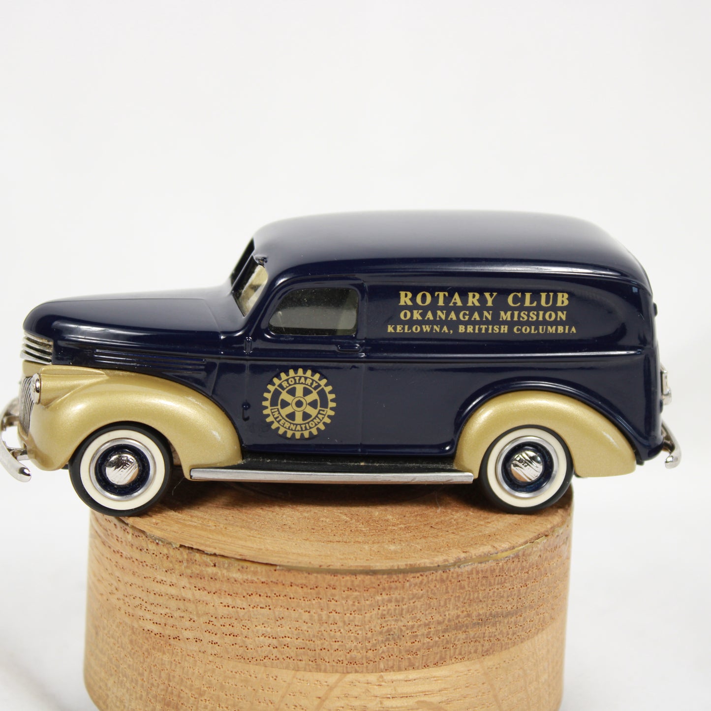 Model of a vintage truck with 'Rotary Club' branding on a wooden base
