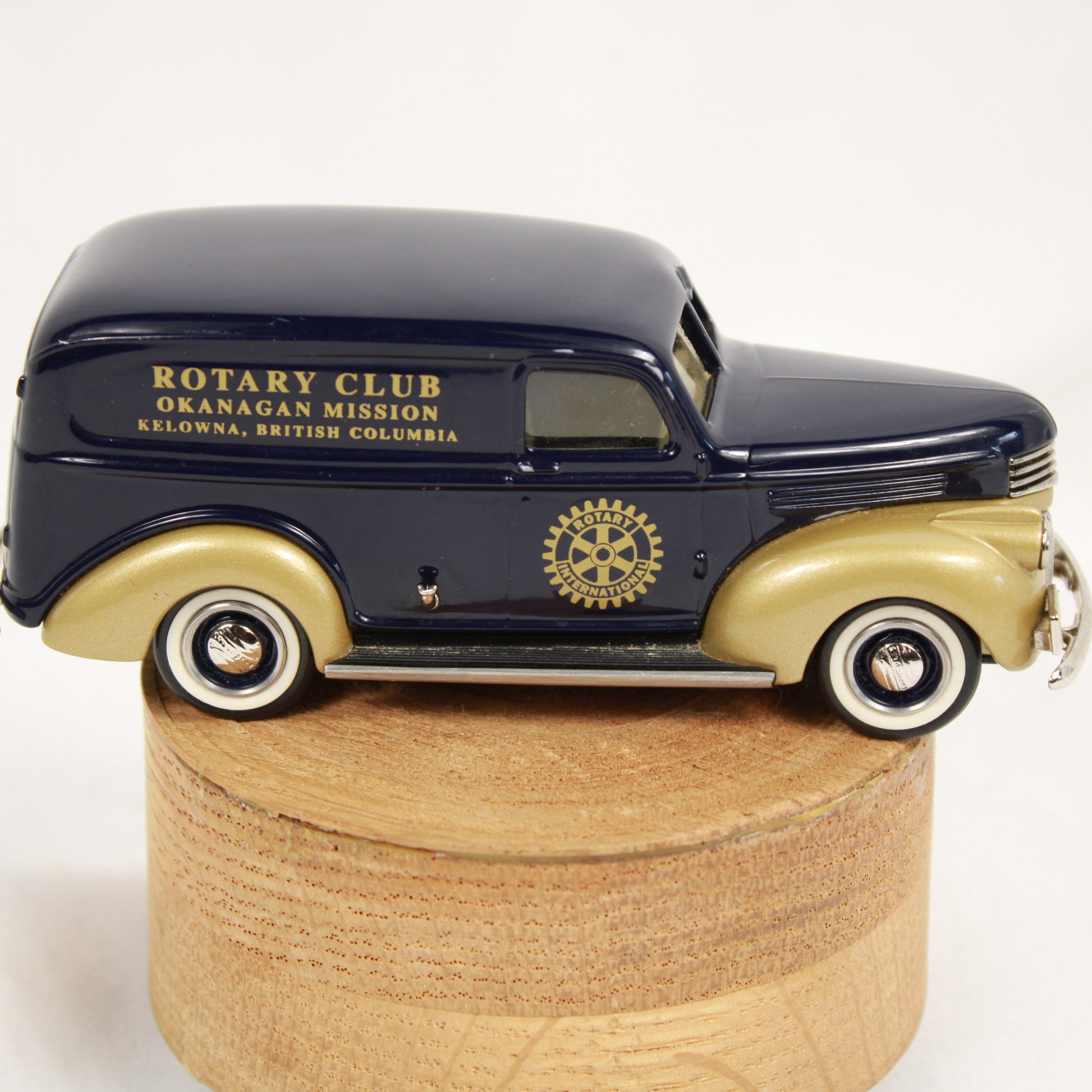 Model of a vintage car with Rotary Club branding on a wooden base