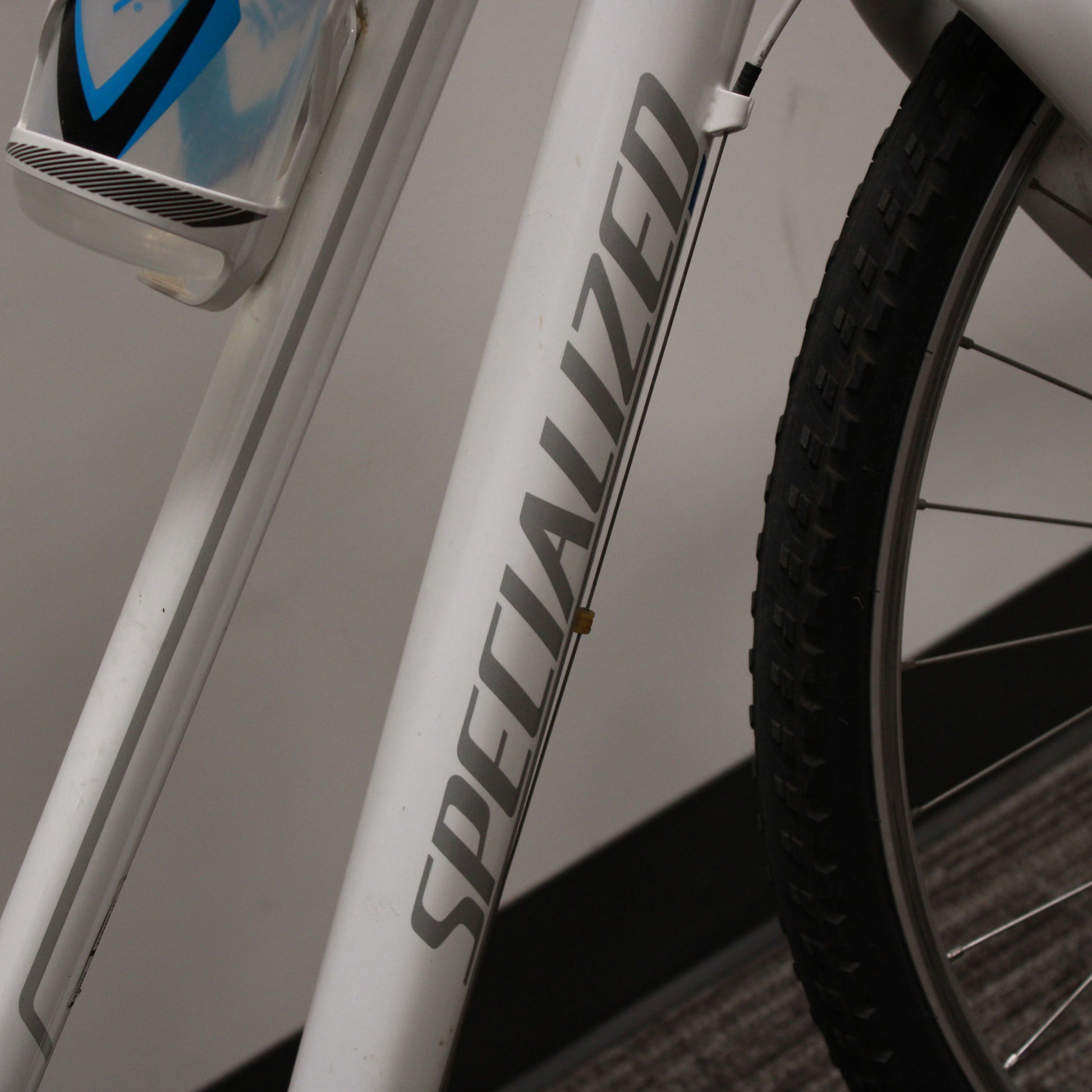 Close-up of a bicycle frame with 'Specialized' branding on a blurred background