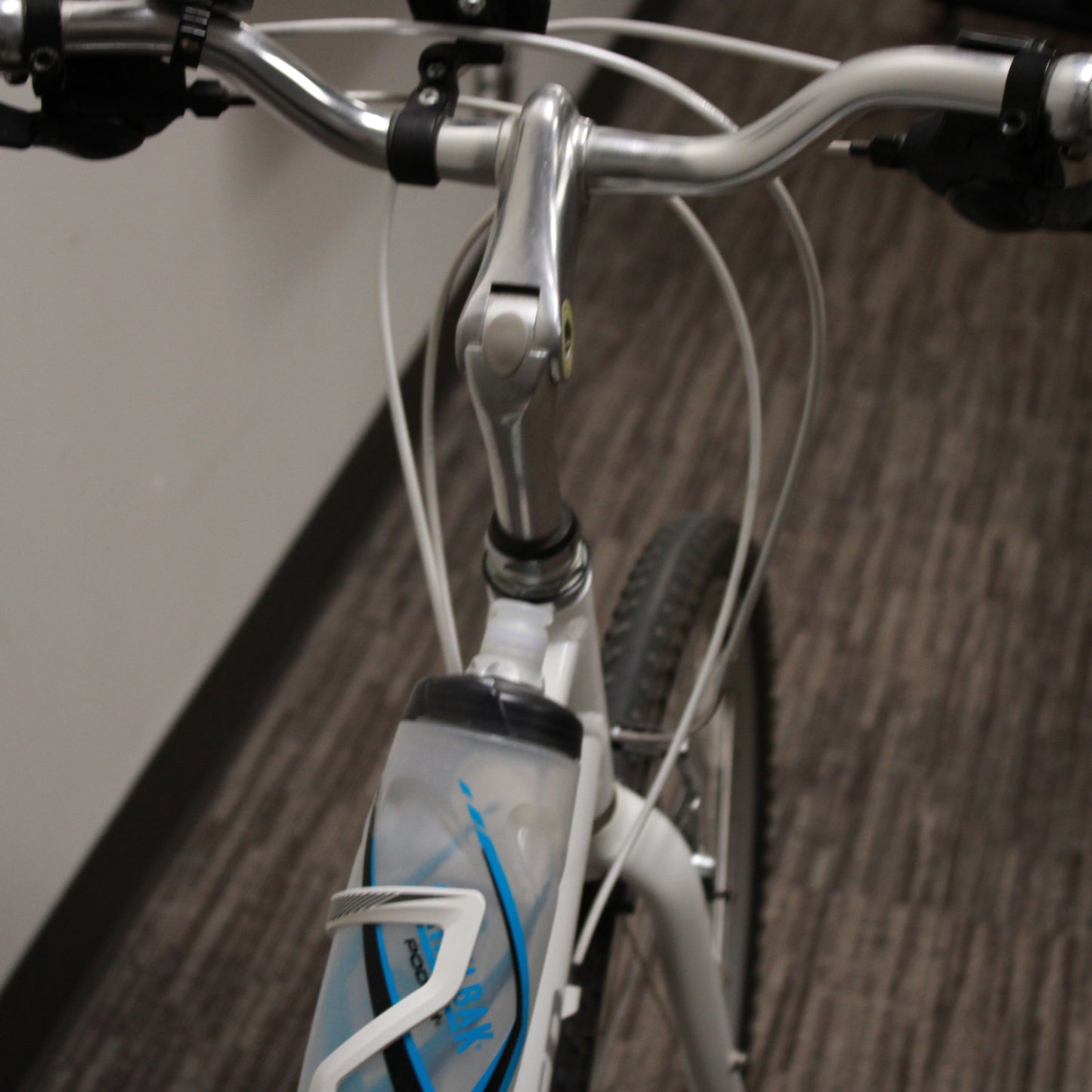 Close-up of a bicycle handlebar with a blurred background