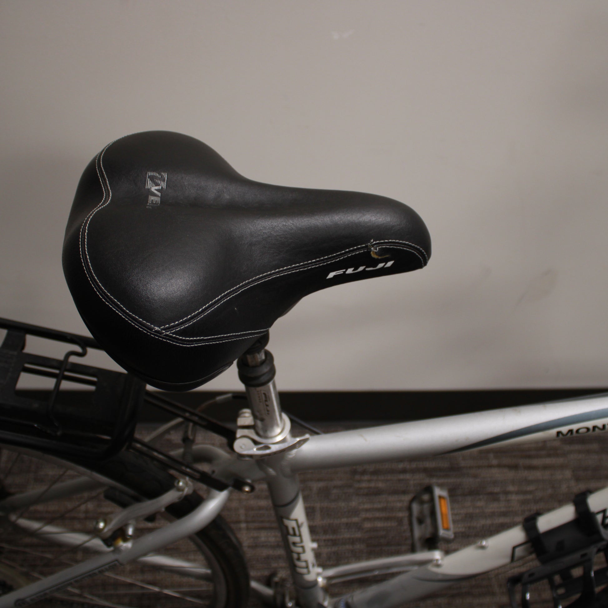 Close-up of a bicycle seat with a blurred background