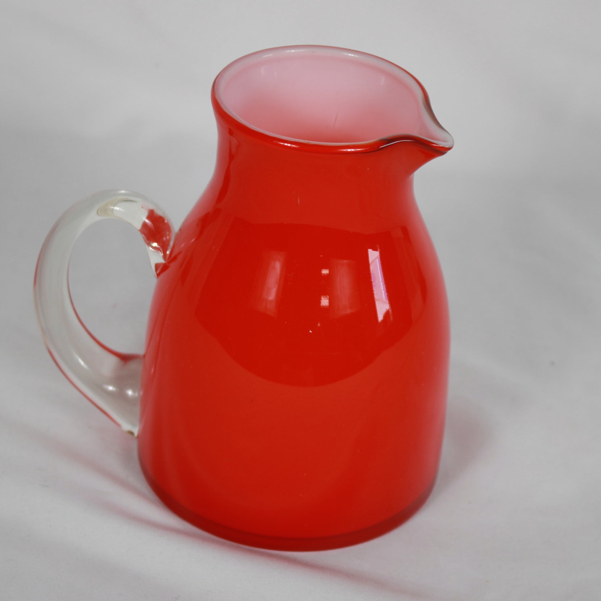 Red Cased Art Glass Creamer Pitcher with Clear Applied Handle
